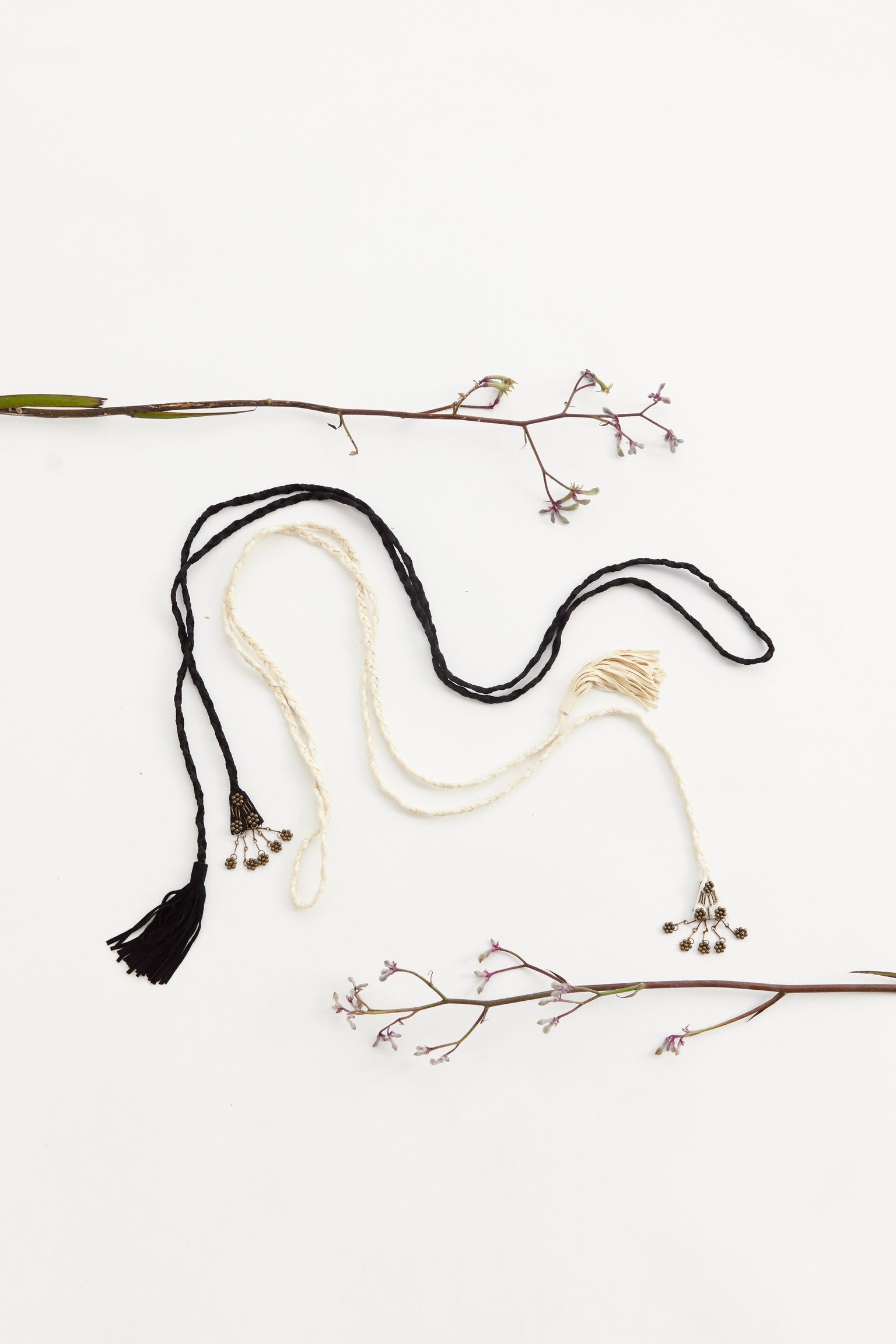 In situ image of a cream and black thin belt.
