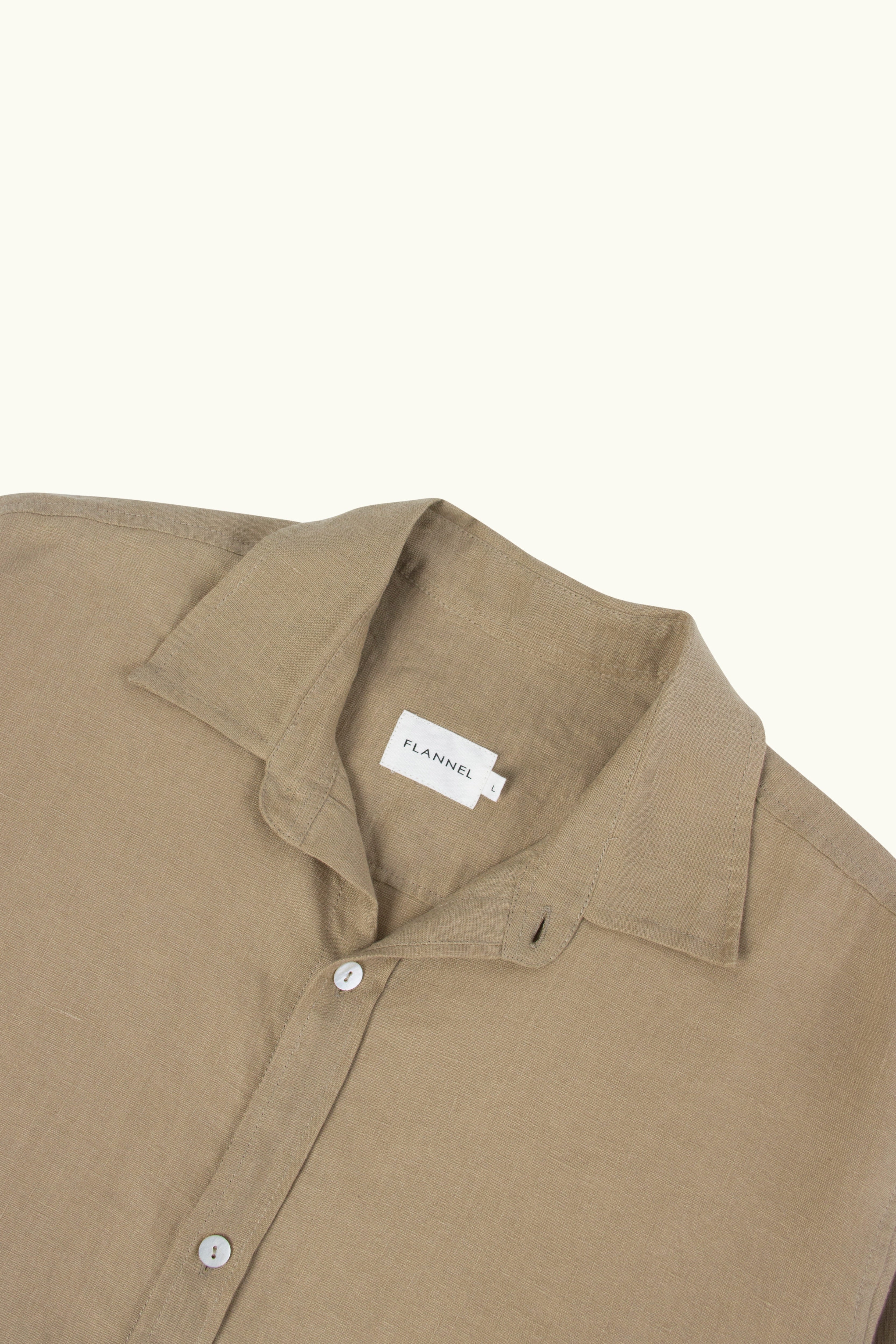 Mocha shirt close up of collar and front button details on a white background