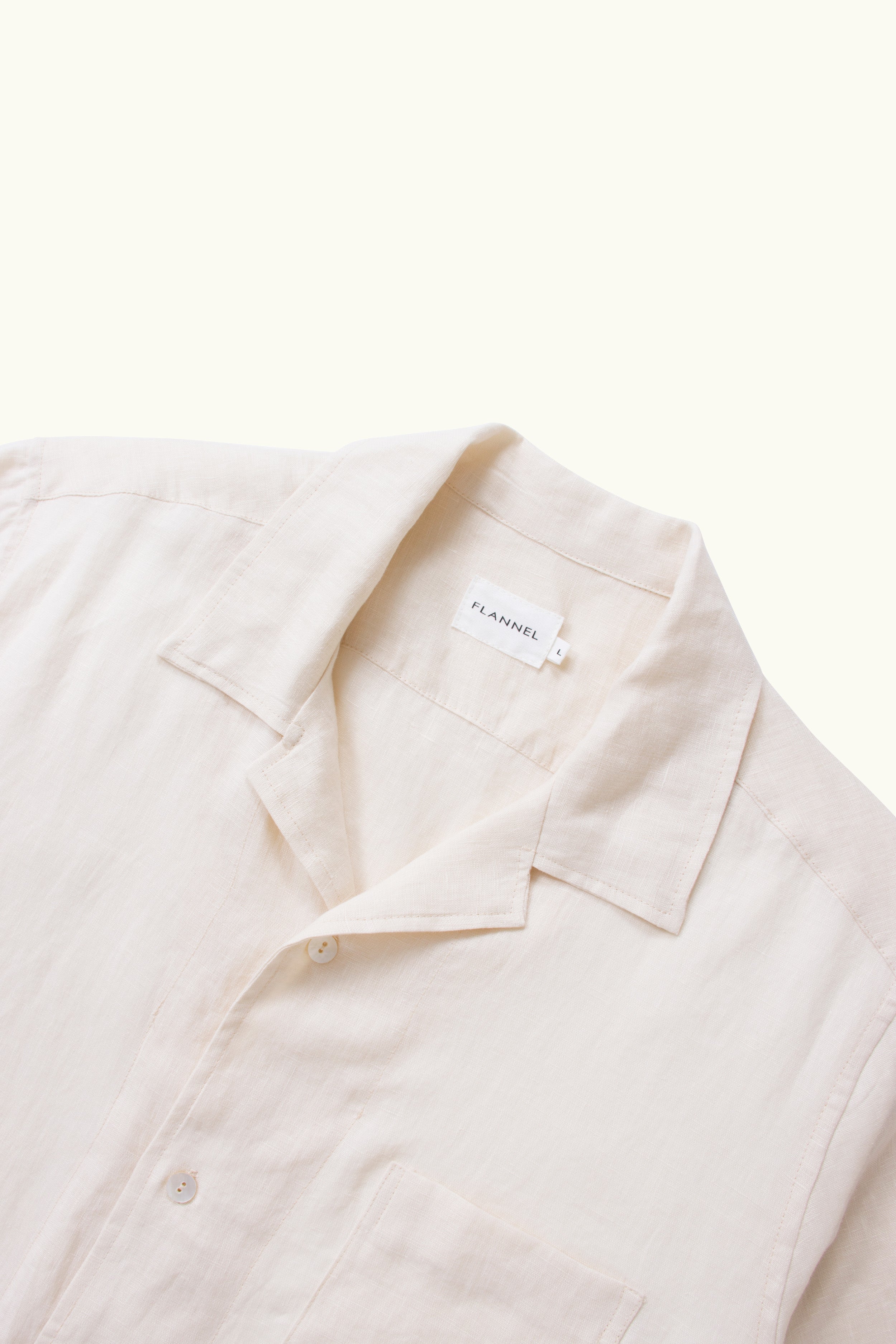 Close up of natural linen short sleeve shirt with on a white background