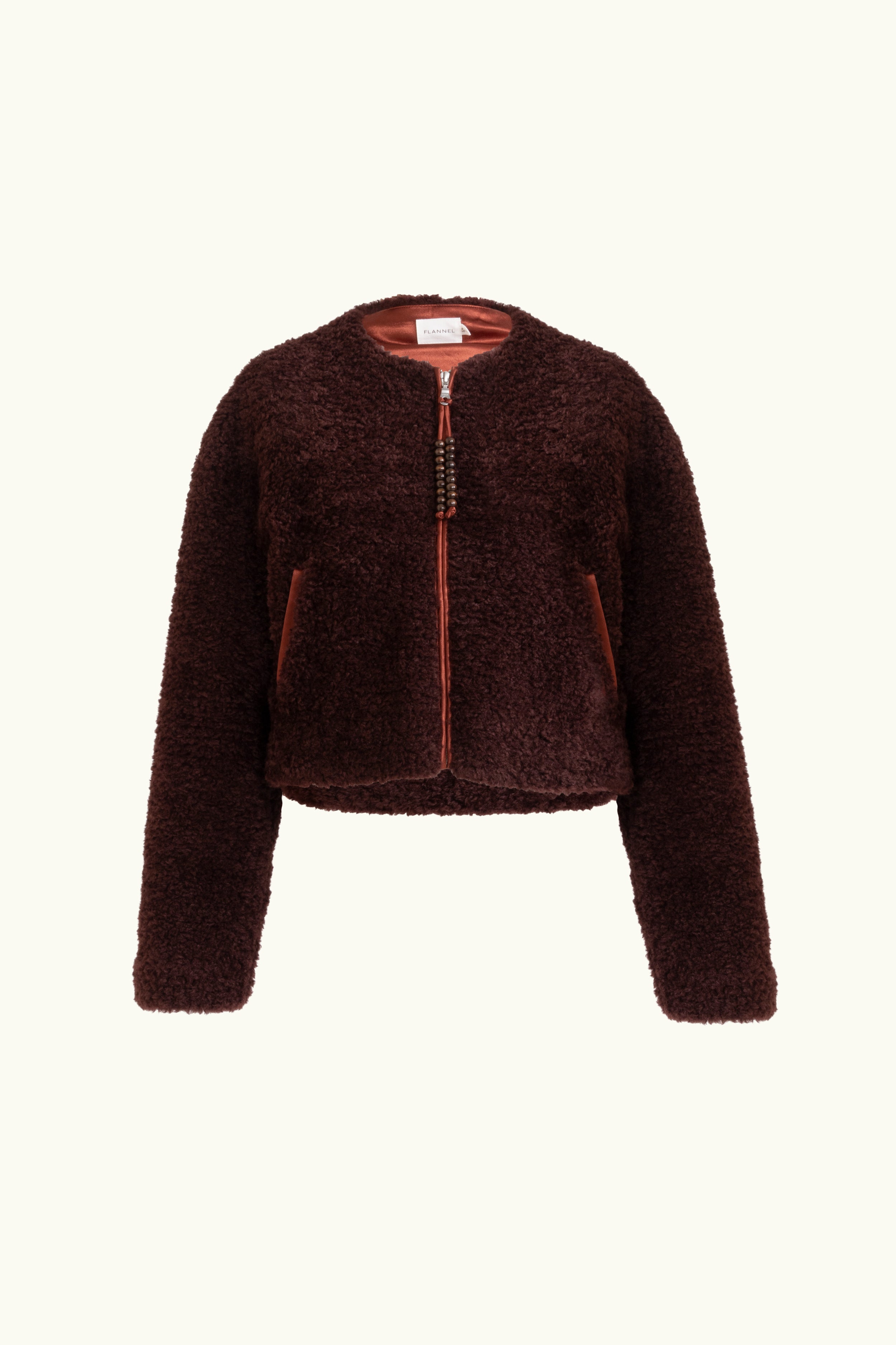 Faux fur port jacket with beaded zip up tassels on a white background
