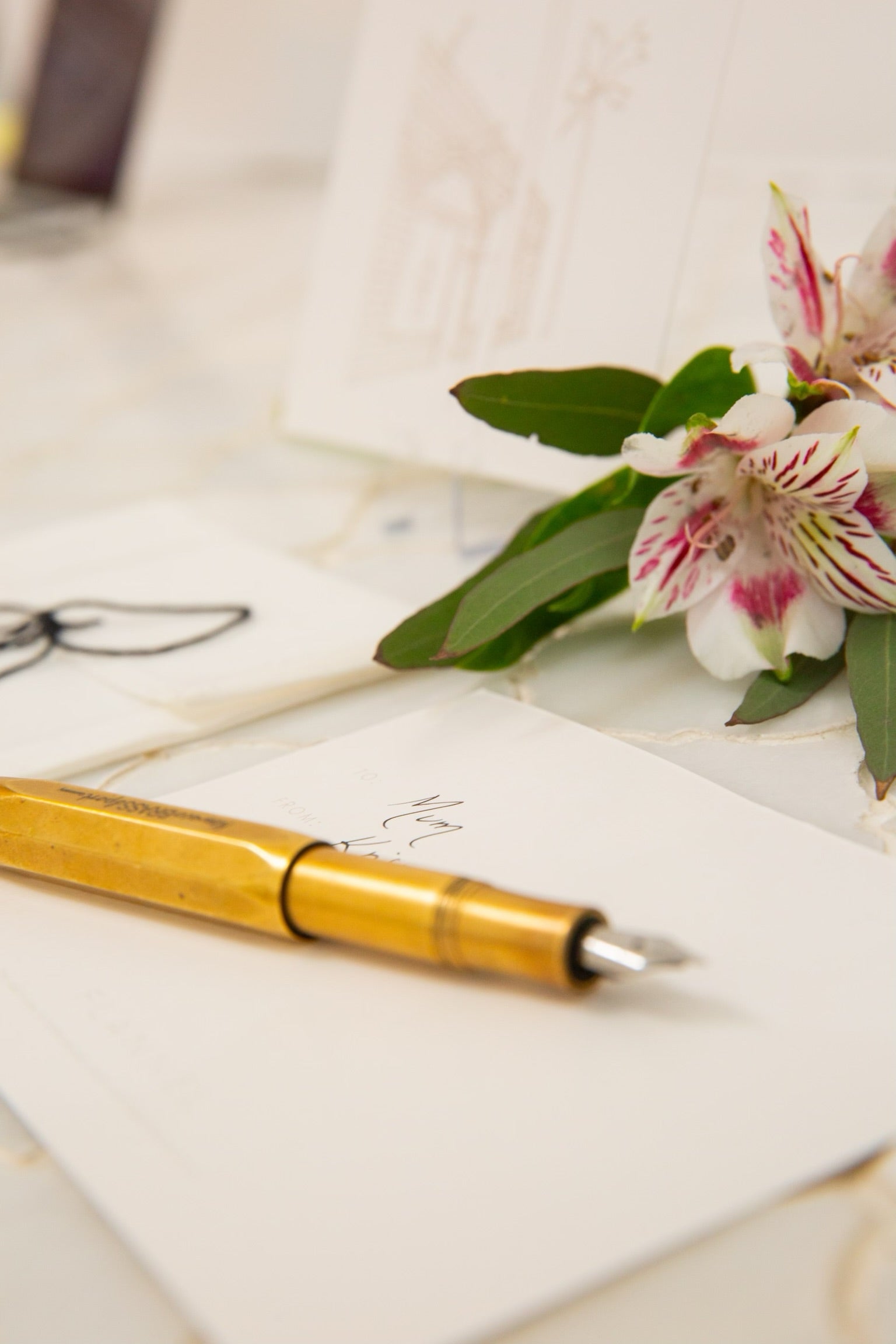 Close up image of a pen that has been used to write a card.