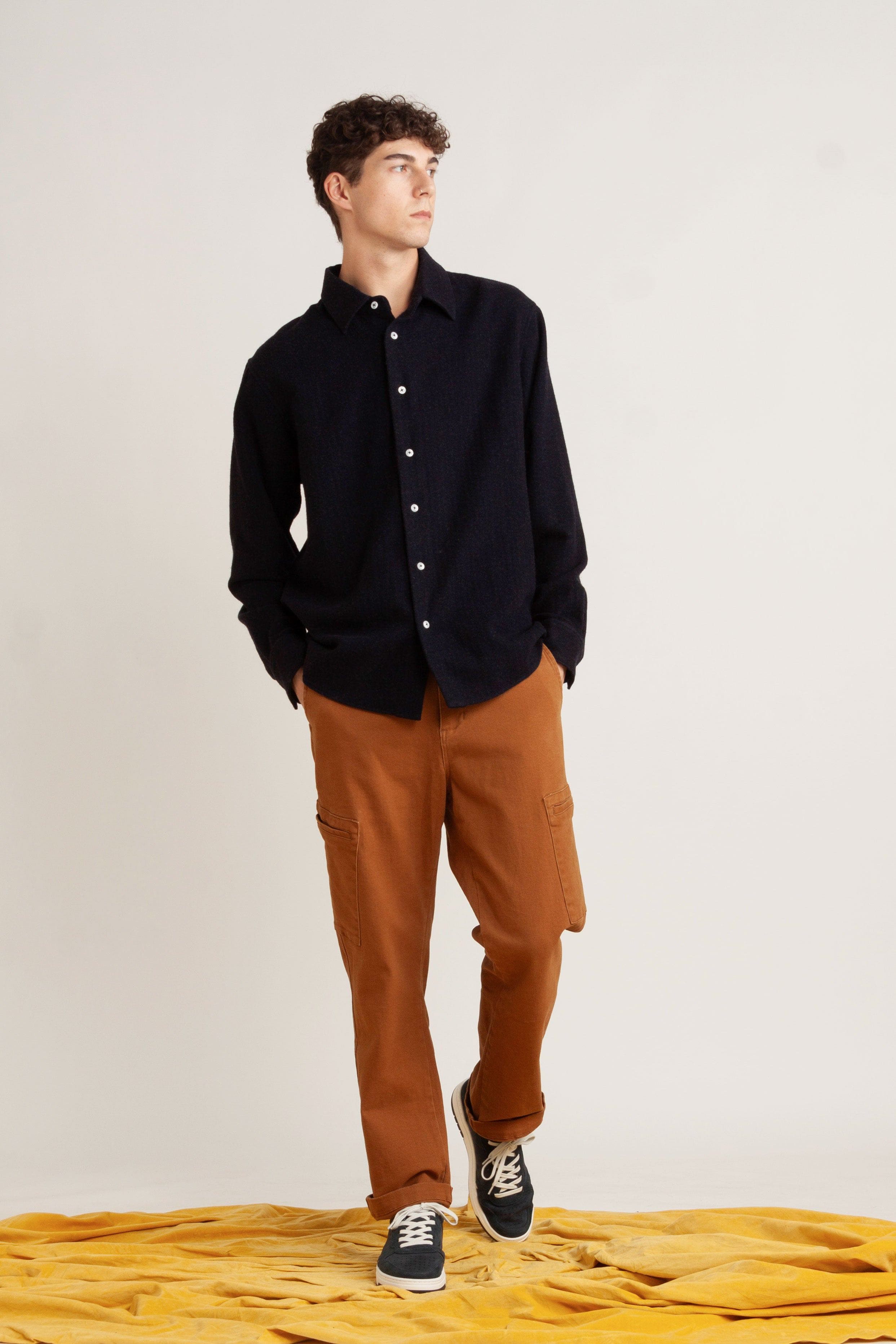 model wearing navy cotton long sleeve shirt, with burnt orange cotton pant and navy sneakers, front view