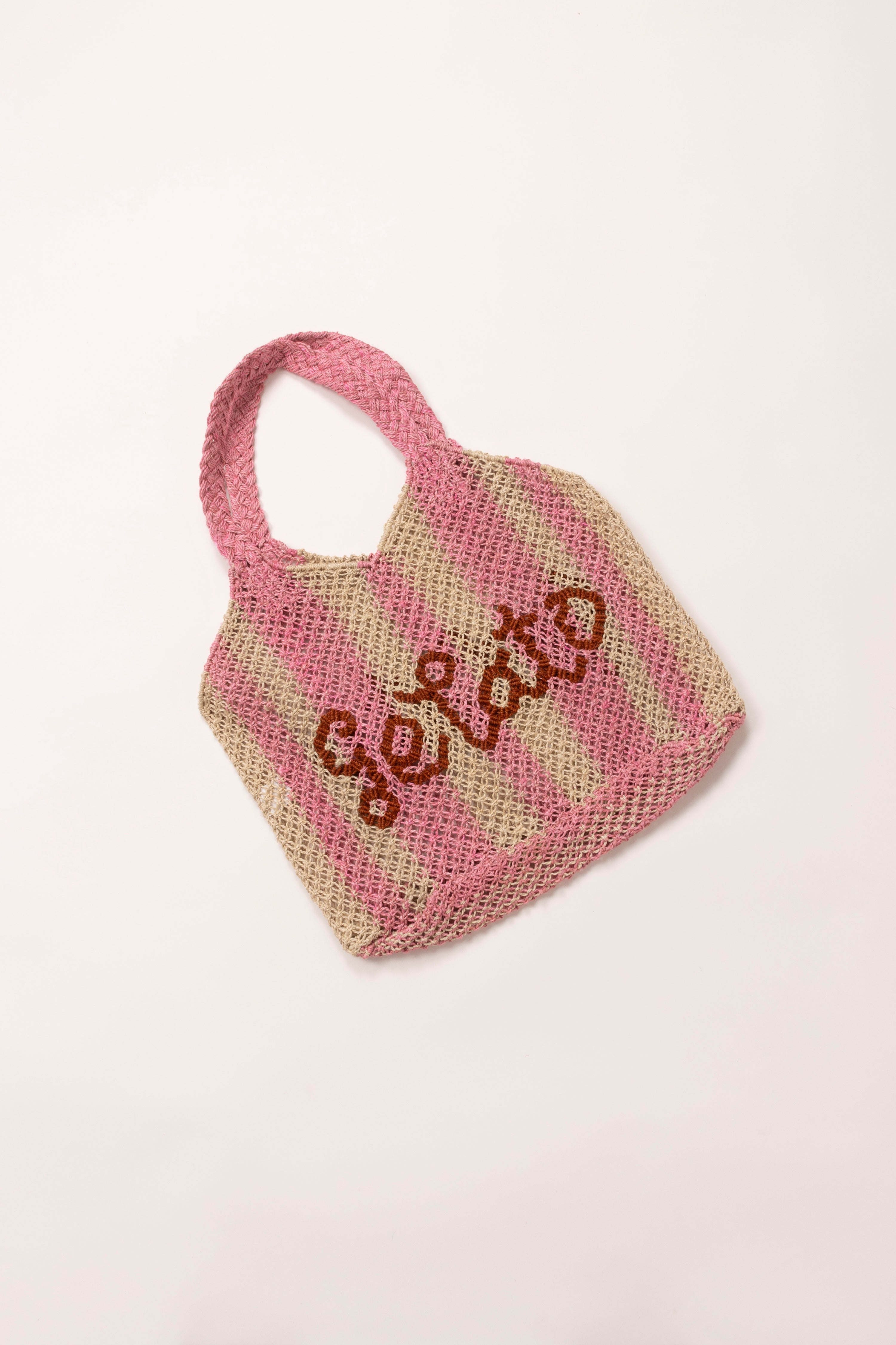 In situ image of raffia pink and white striped bag.