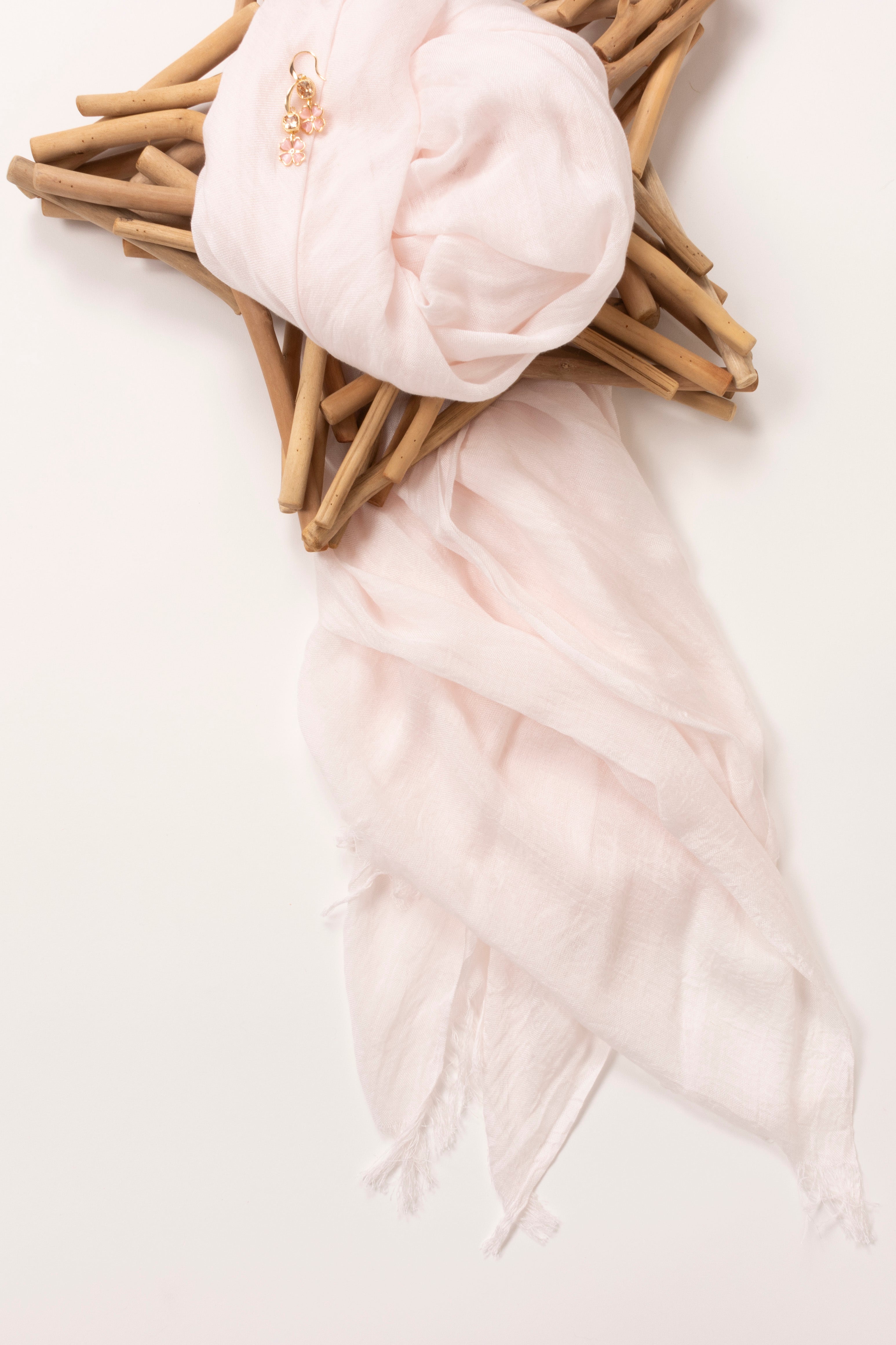 Image of scarf folded onto a star ornament.