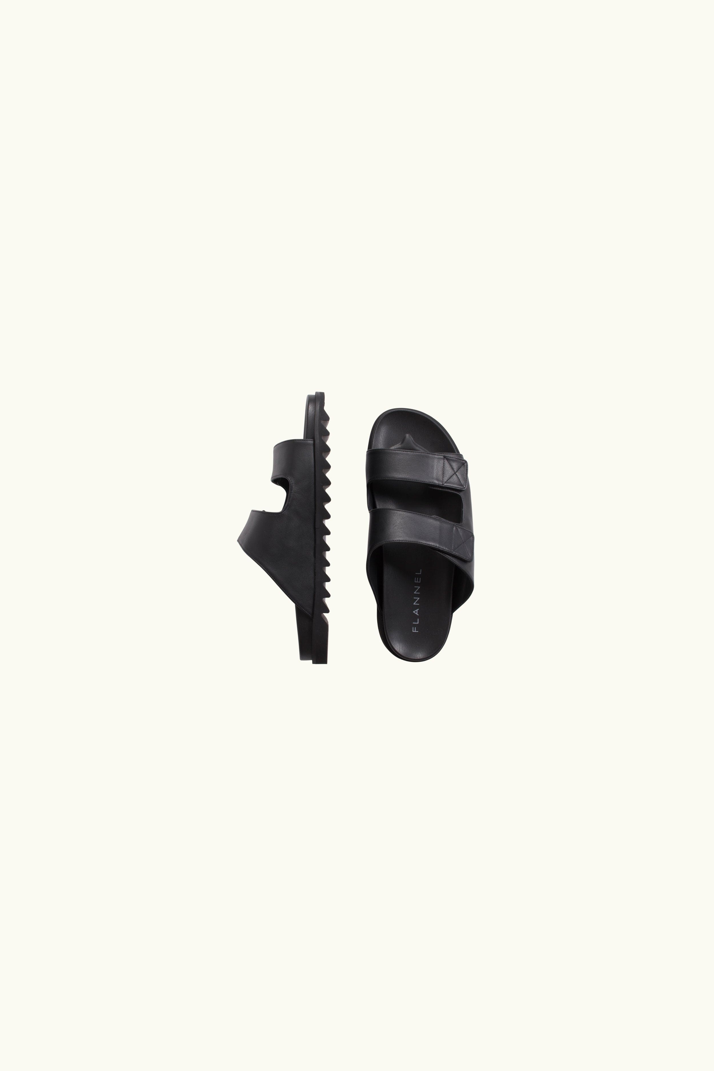 Black leather slides on a white background
