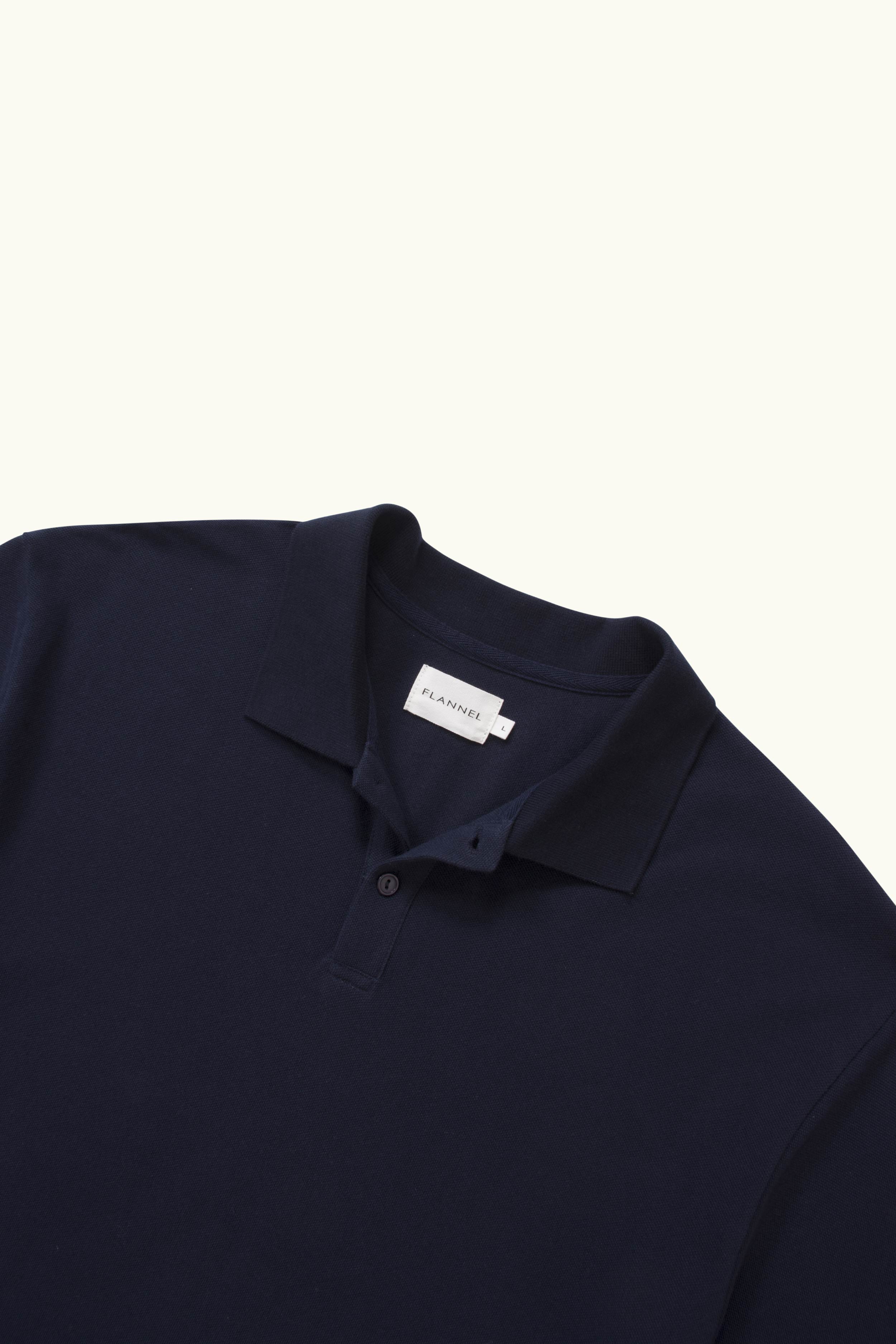 Close up oversized navy polo on white background