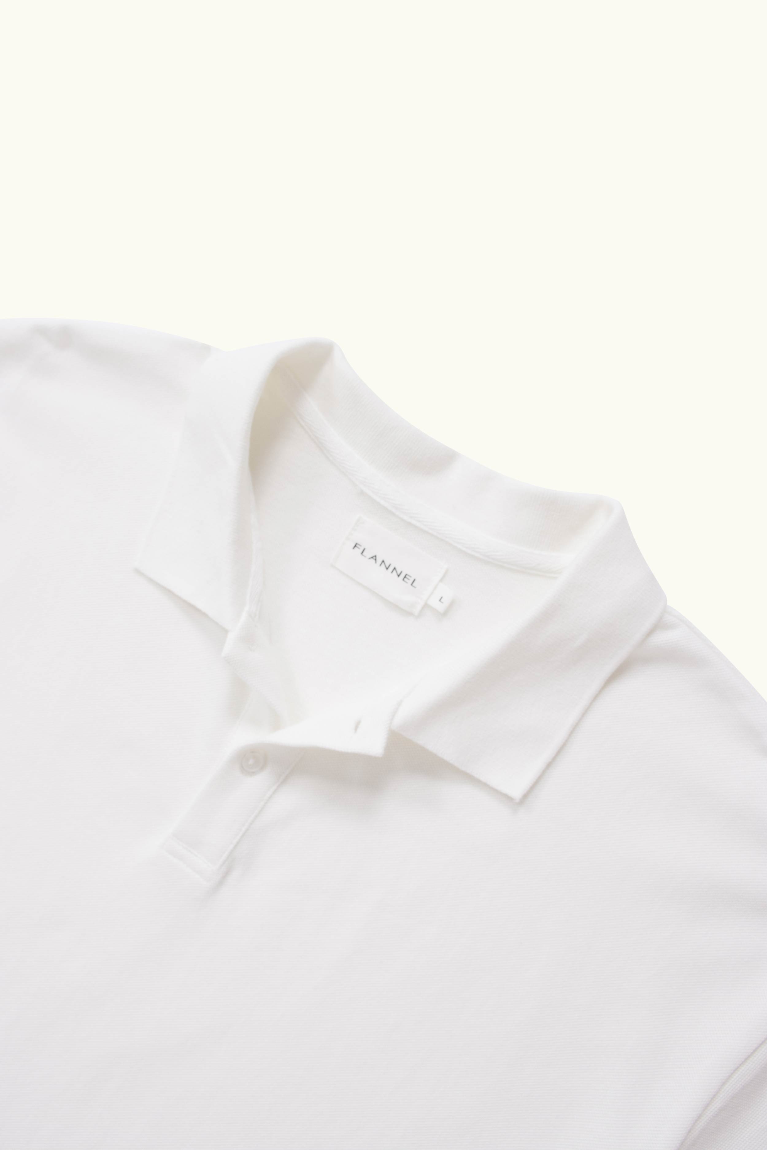 Close-up of a white polo shirt on a white background