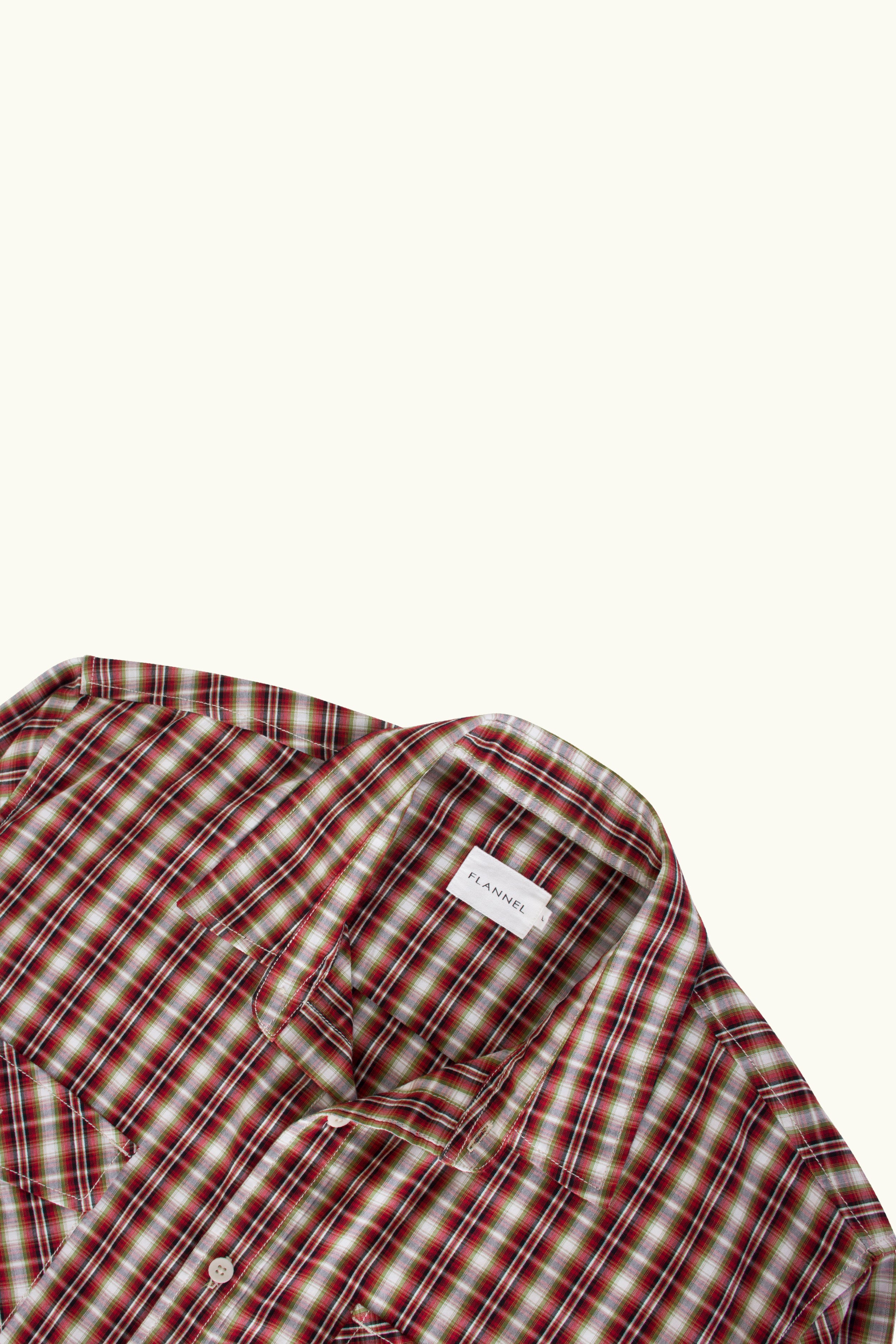 Close up of red and white cotton of plaid shirt on a white background