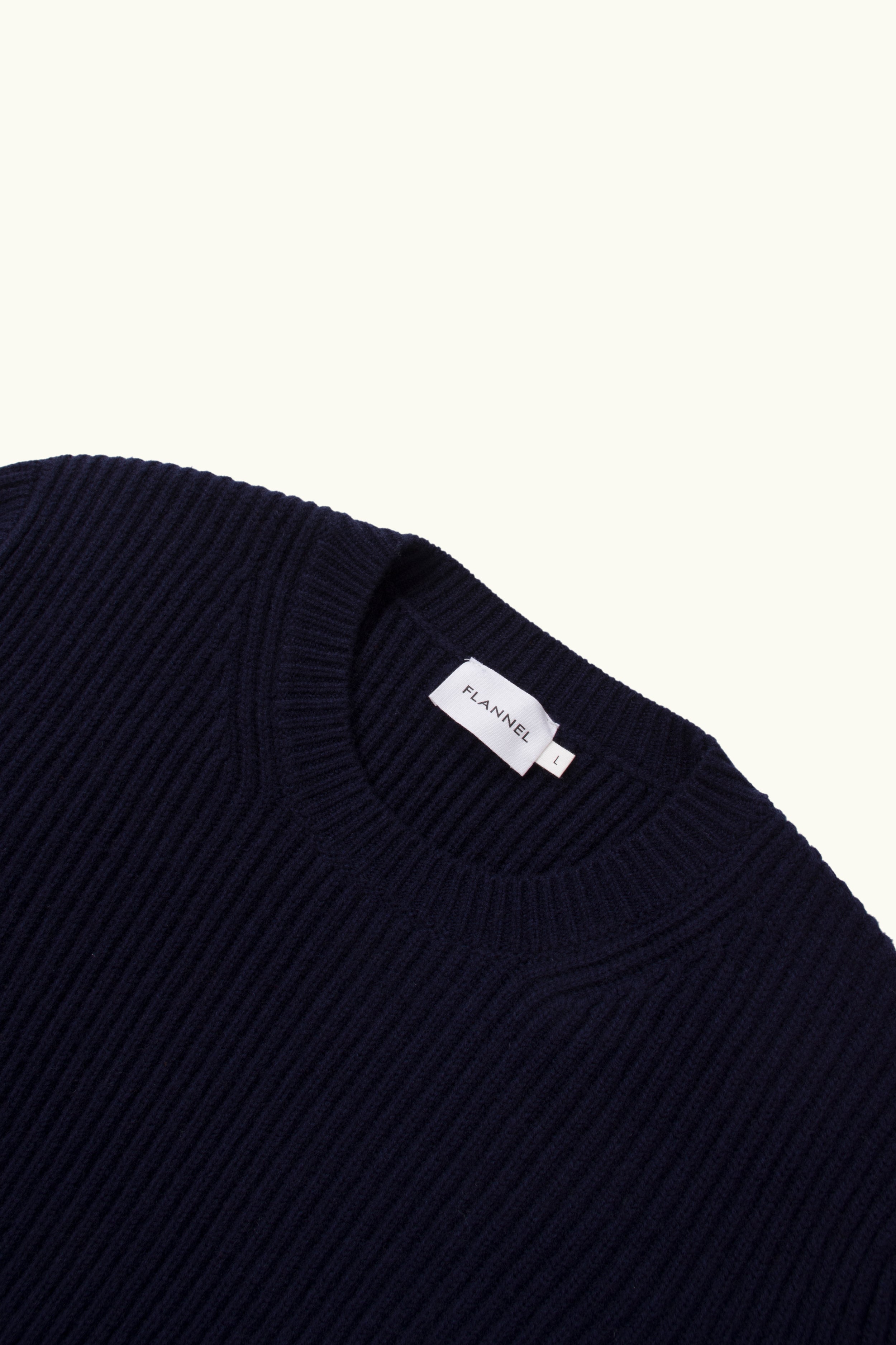 Close up of indigo cashmere wool blend ribbed sweater on a white Background