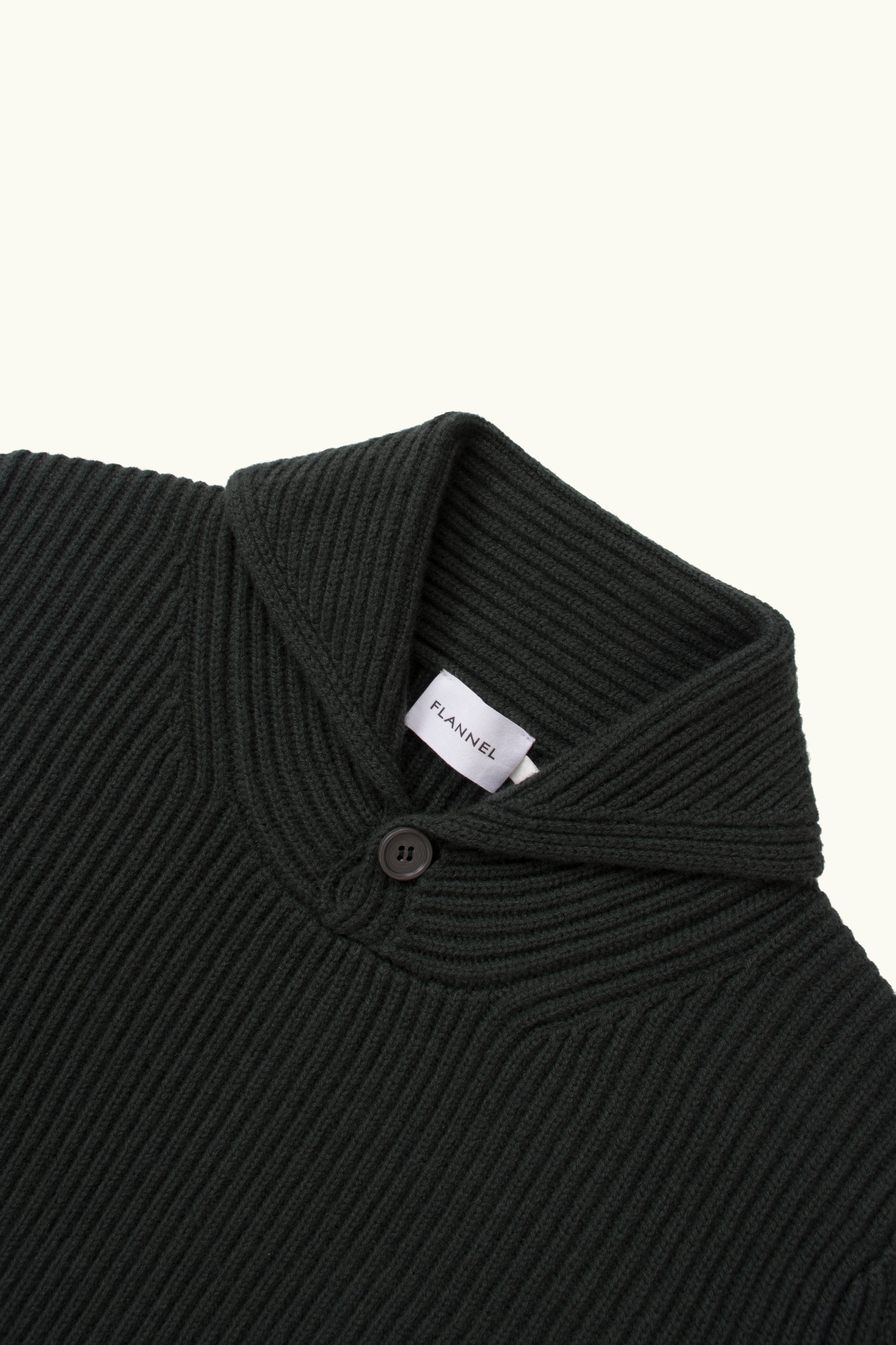 Close-up of Hunter green cashmere wool blend ribbed shawl knit sweater on a white Background