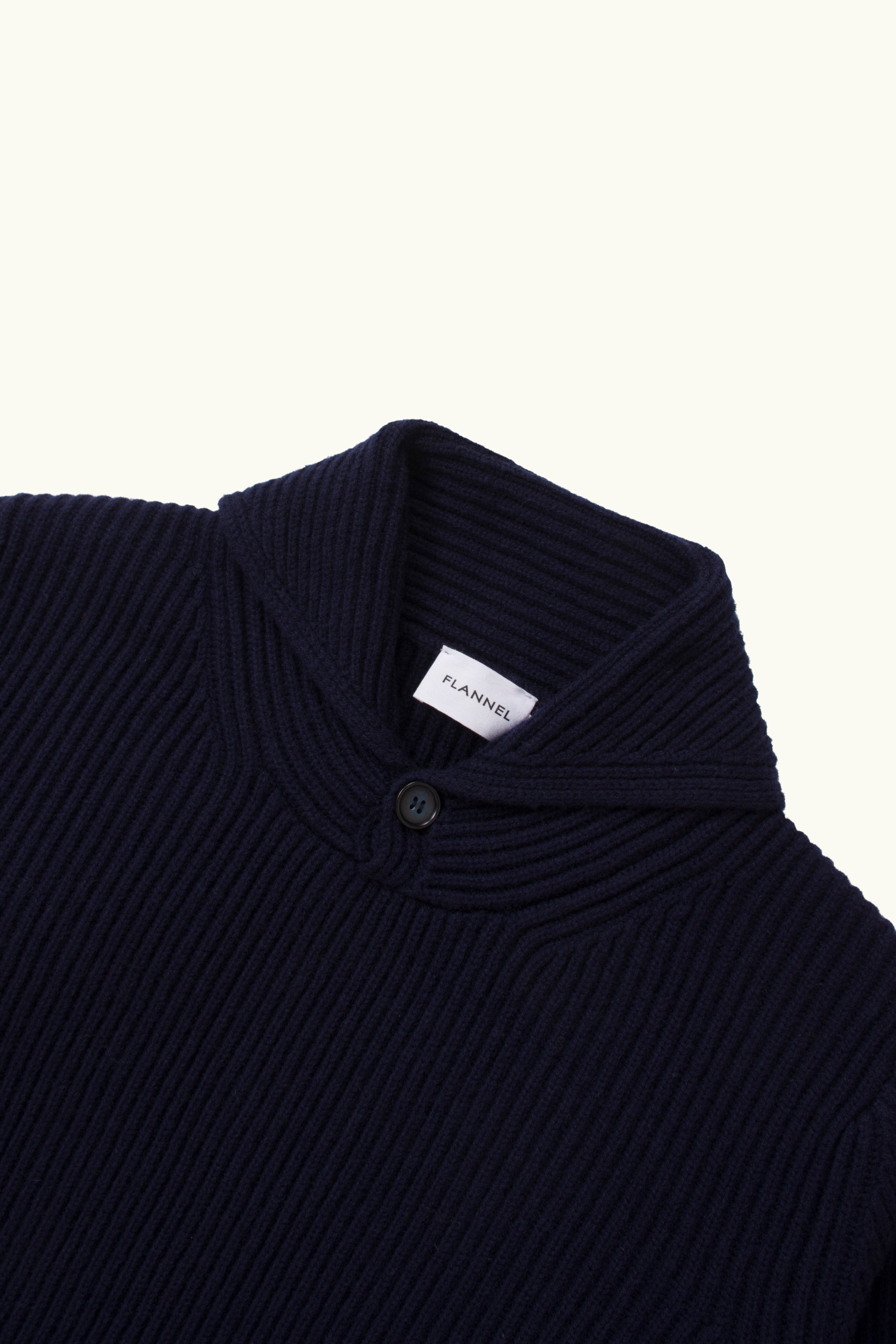 Close up of indigo cashmere wool blend ribbed shawl knit sweater on a white Background