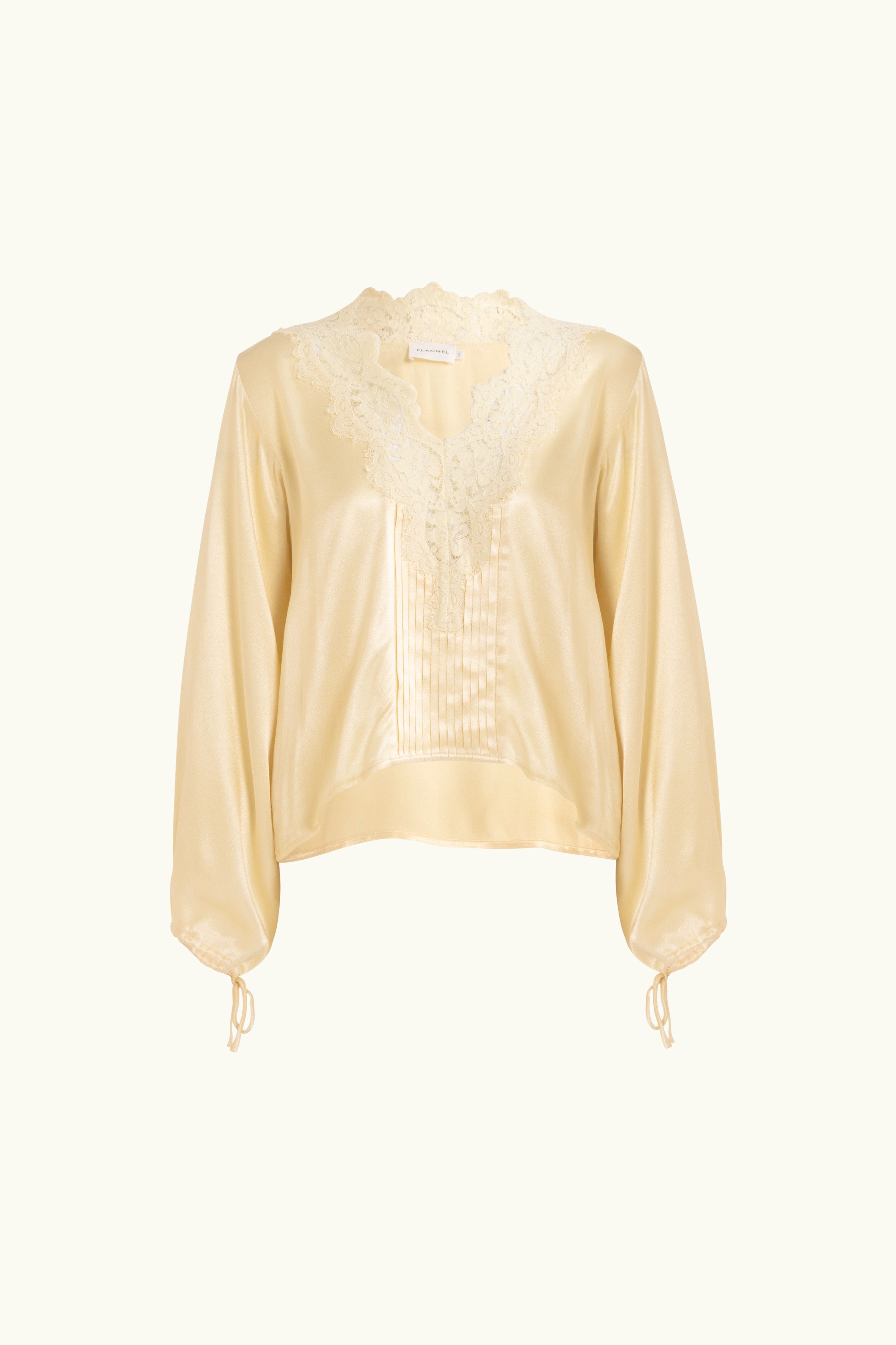 Vanilla lace-lined long sleeve top with a white background