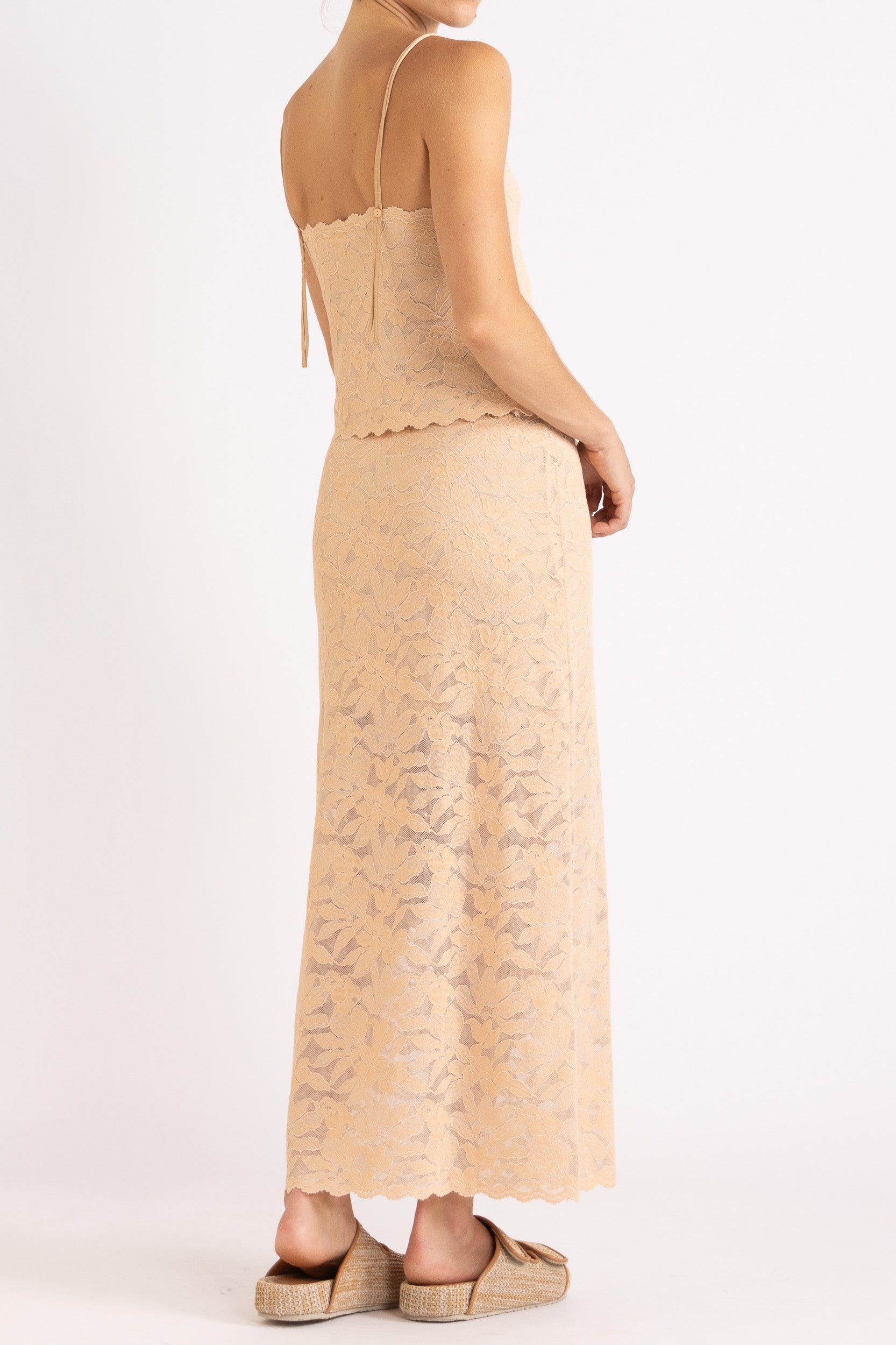 Woman wearing a floral lace camisole and maxi skirt in a biscuit colour way