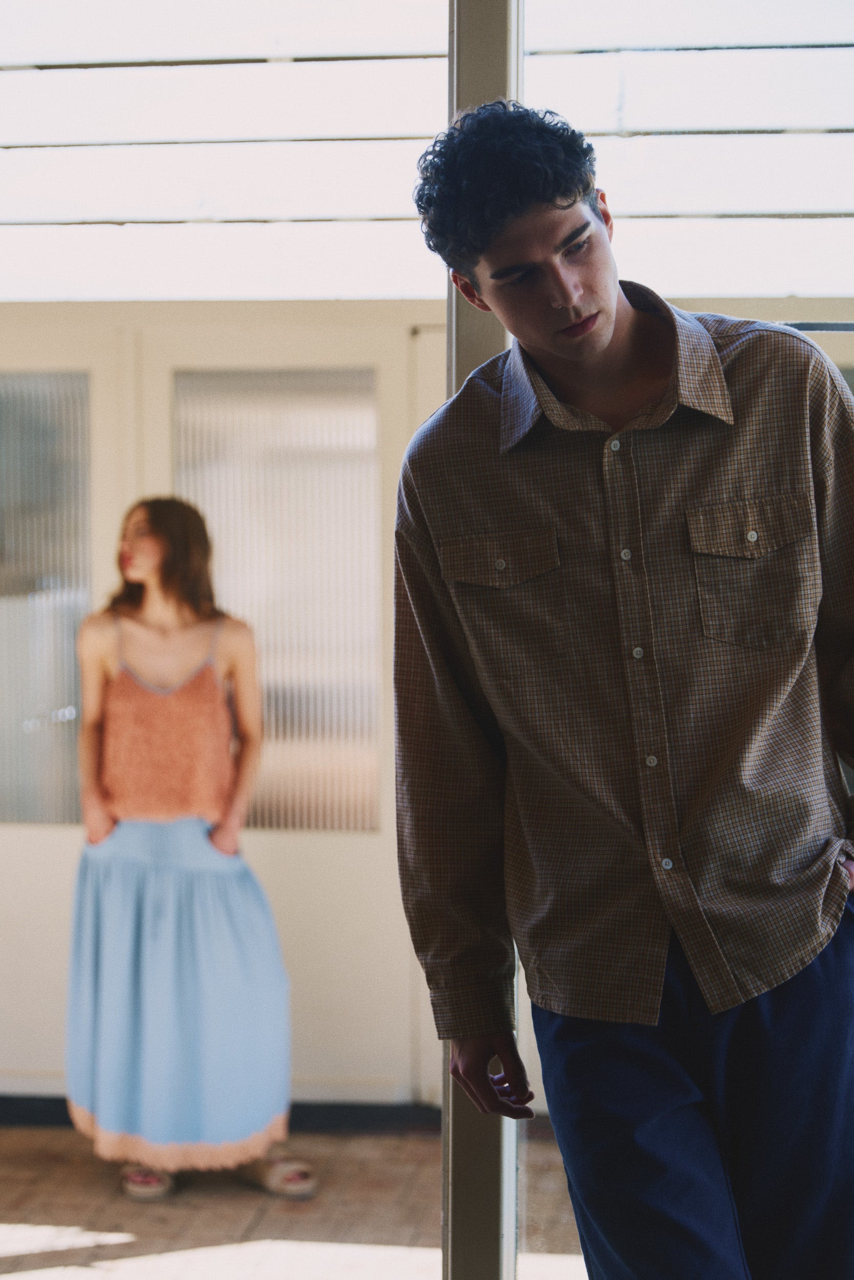 Model wearing camel check cotton shirt with blue cotton pant, campaign image