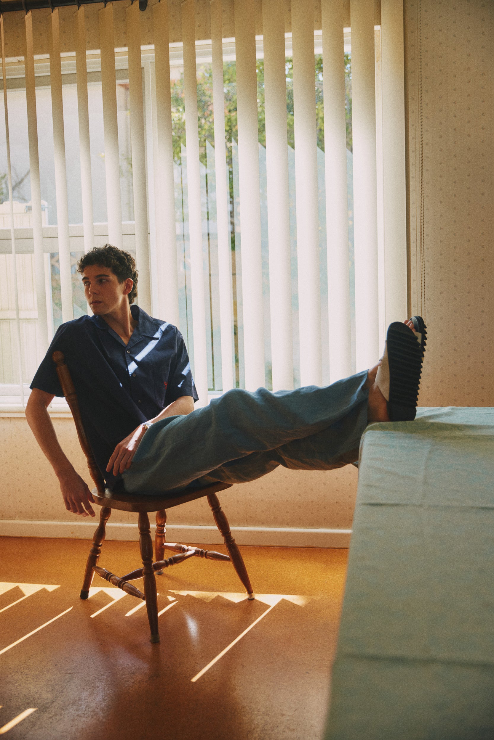 Model wearing navy blue cotton shirt and steel blue linen pant, campaign image