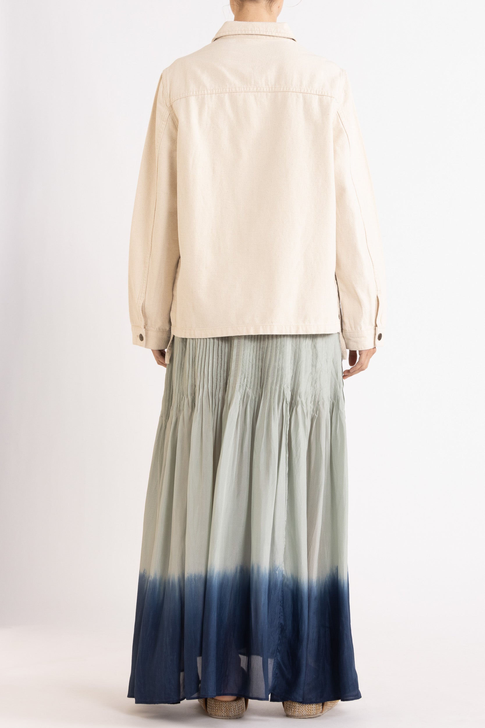Model wearing cream cotton-twill utility jacket & sky blue dip-dye silk dress, back view