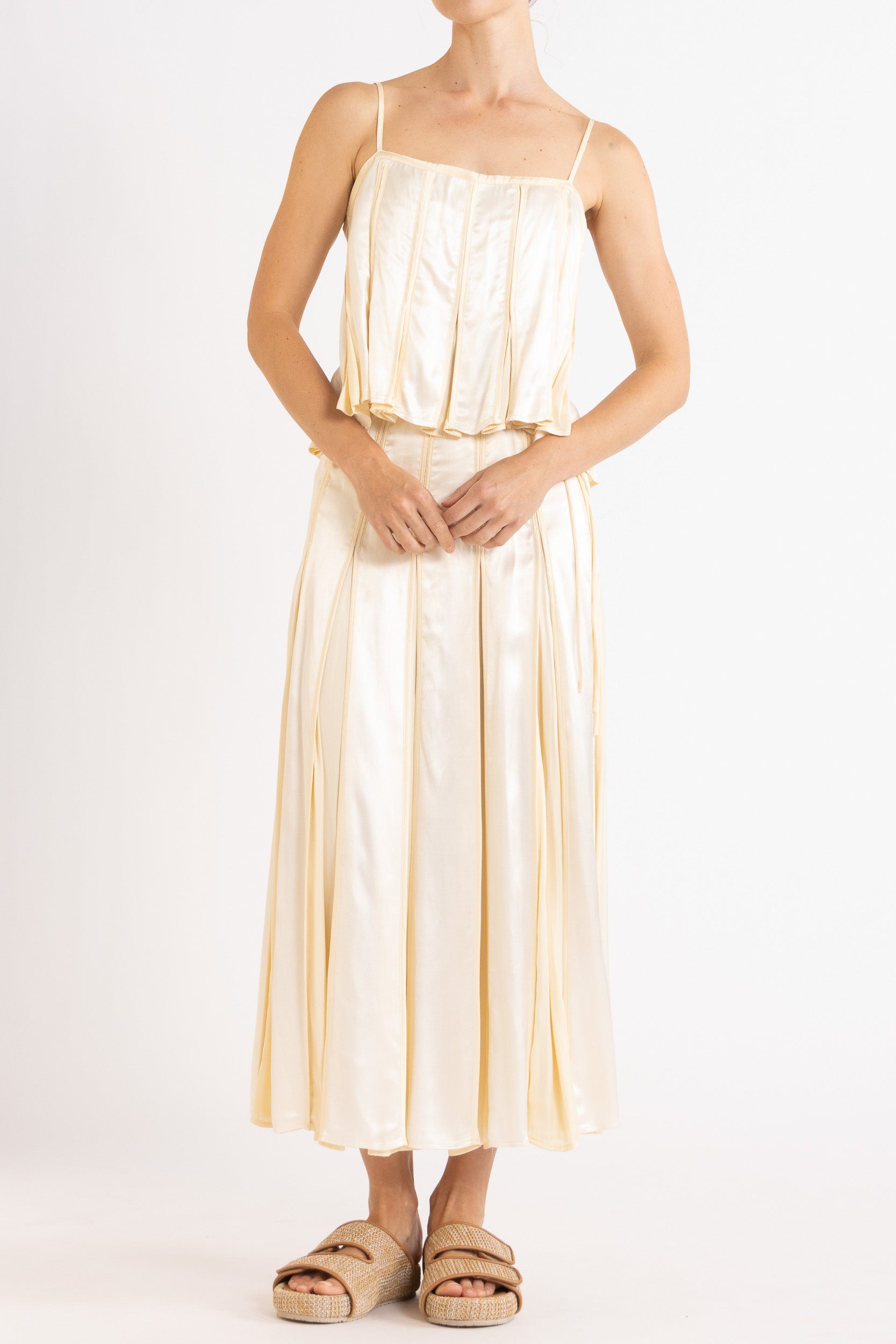 Model wearing cream box pleat camisole & skirt, front view