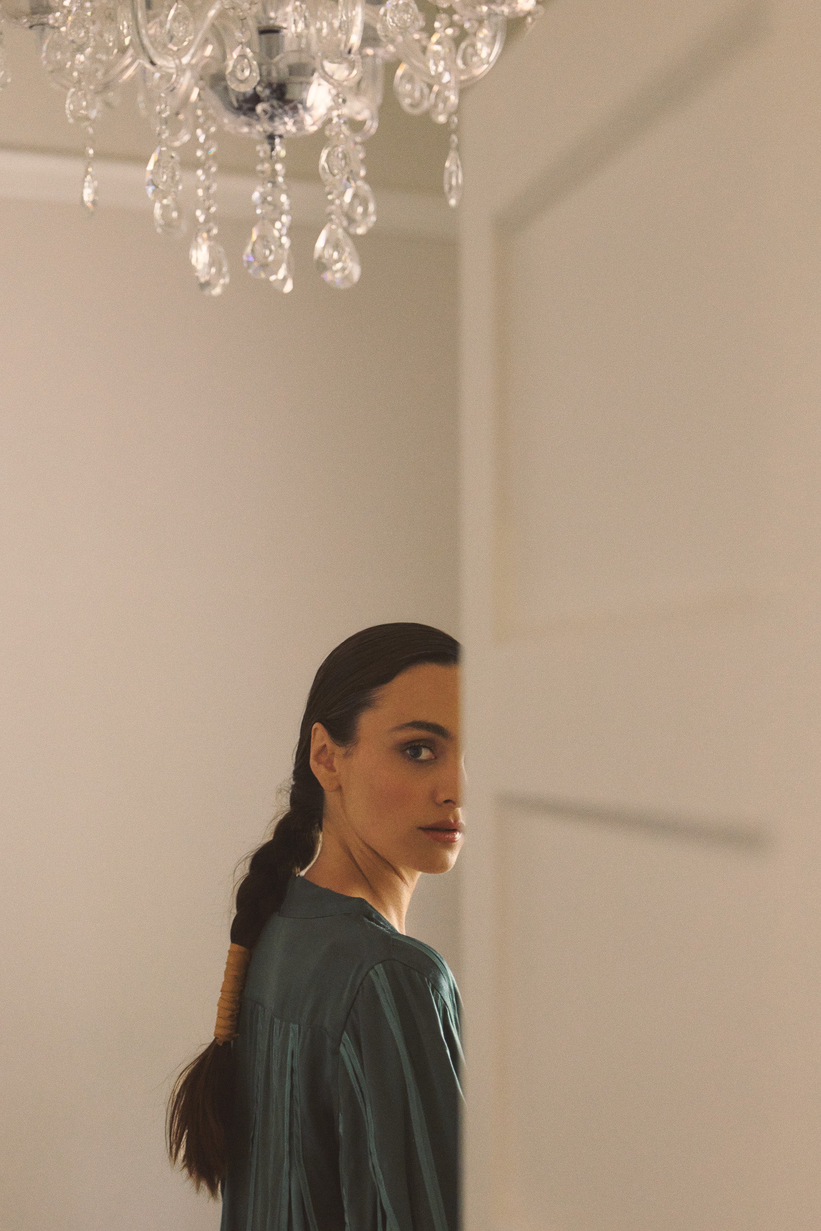 Model wearing green box pleat jacket, close-up campaign image