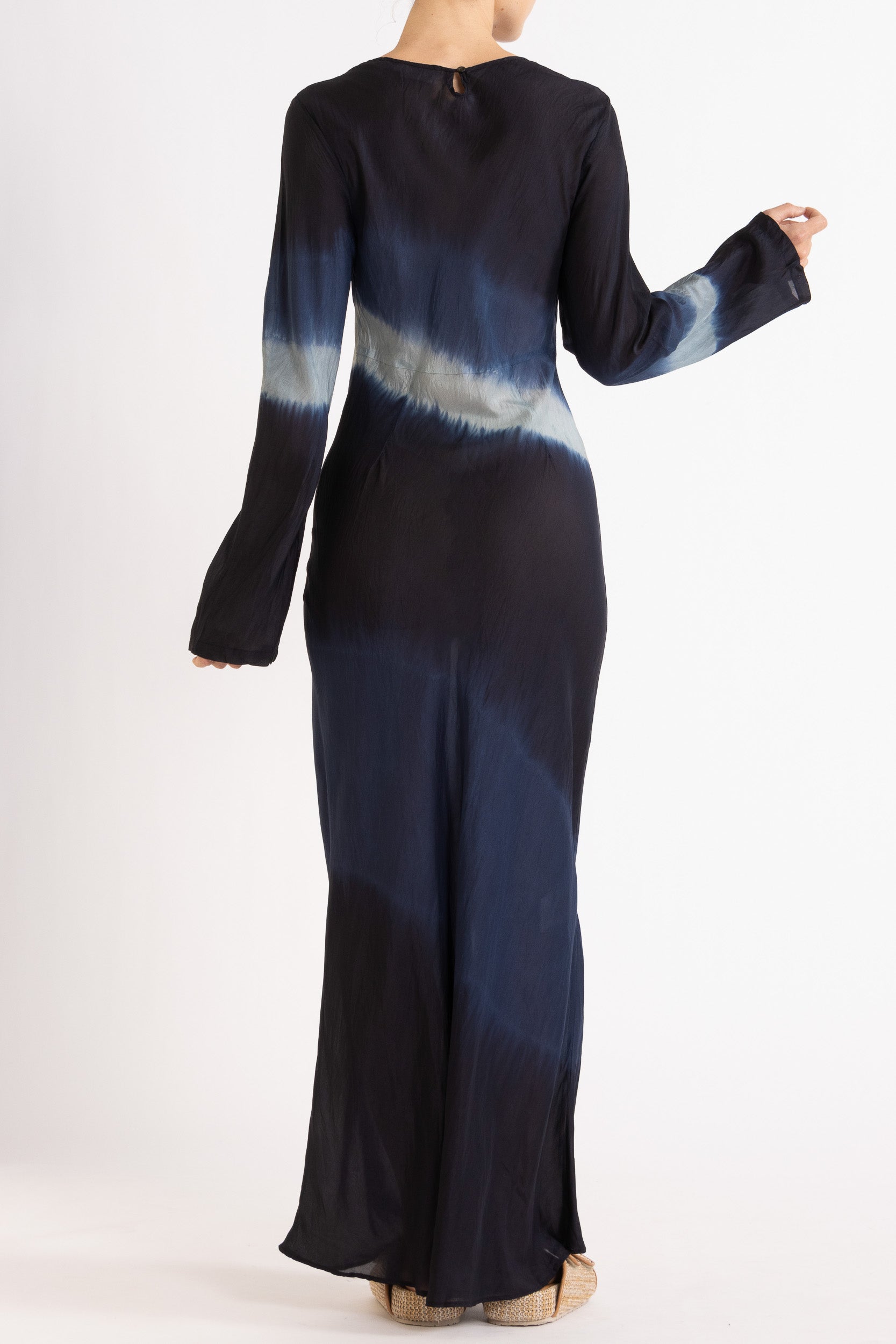 Woman wearing a silk Habotai long Sleeve maxi dress hand tie dyed in ocean tones