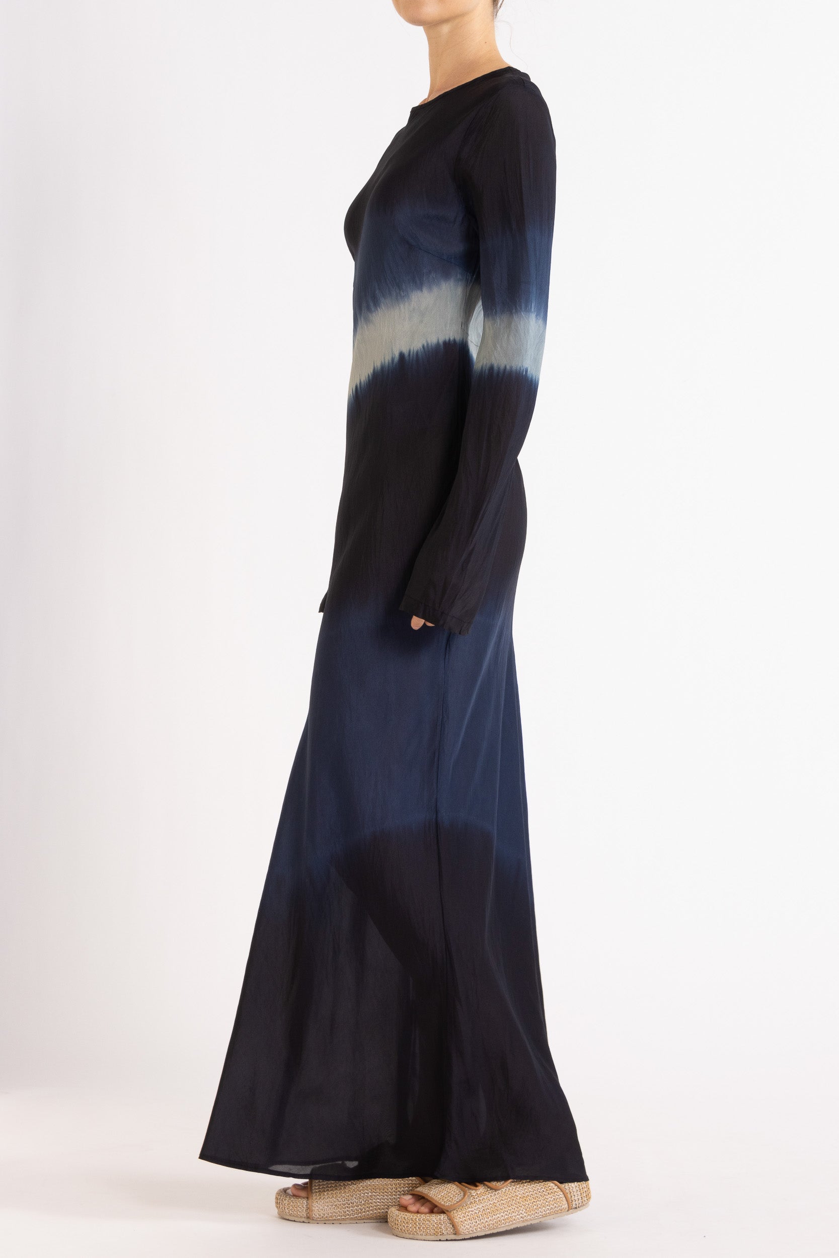 Woman wearing a silk Habotai long Sleeve maxi dress hand tie dyed in ocean tones