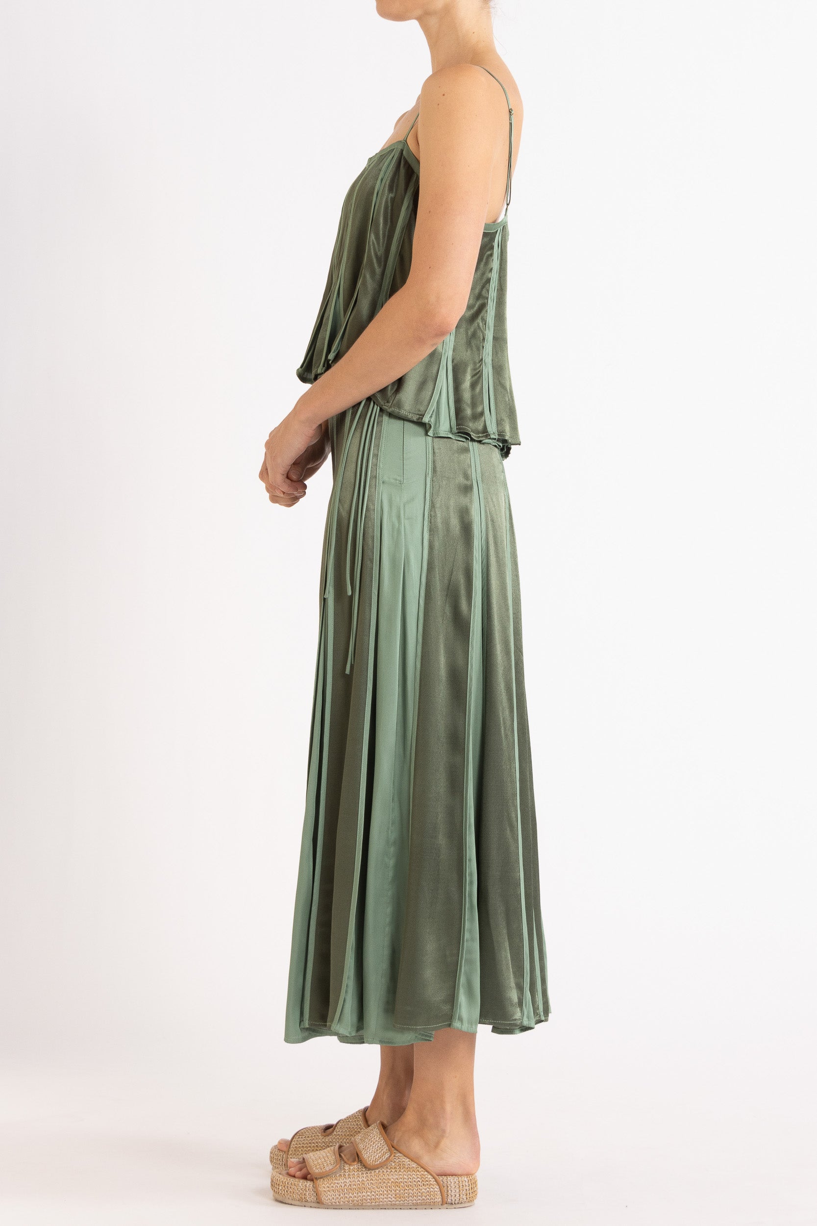 Model wearing cream box pleat camisole & skirt, side view