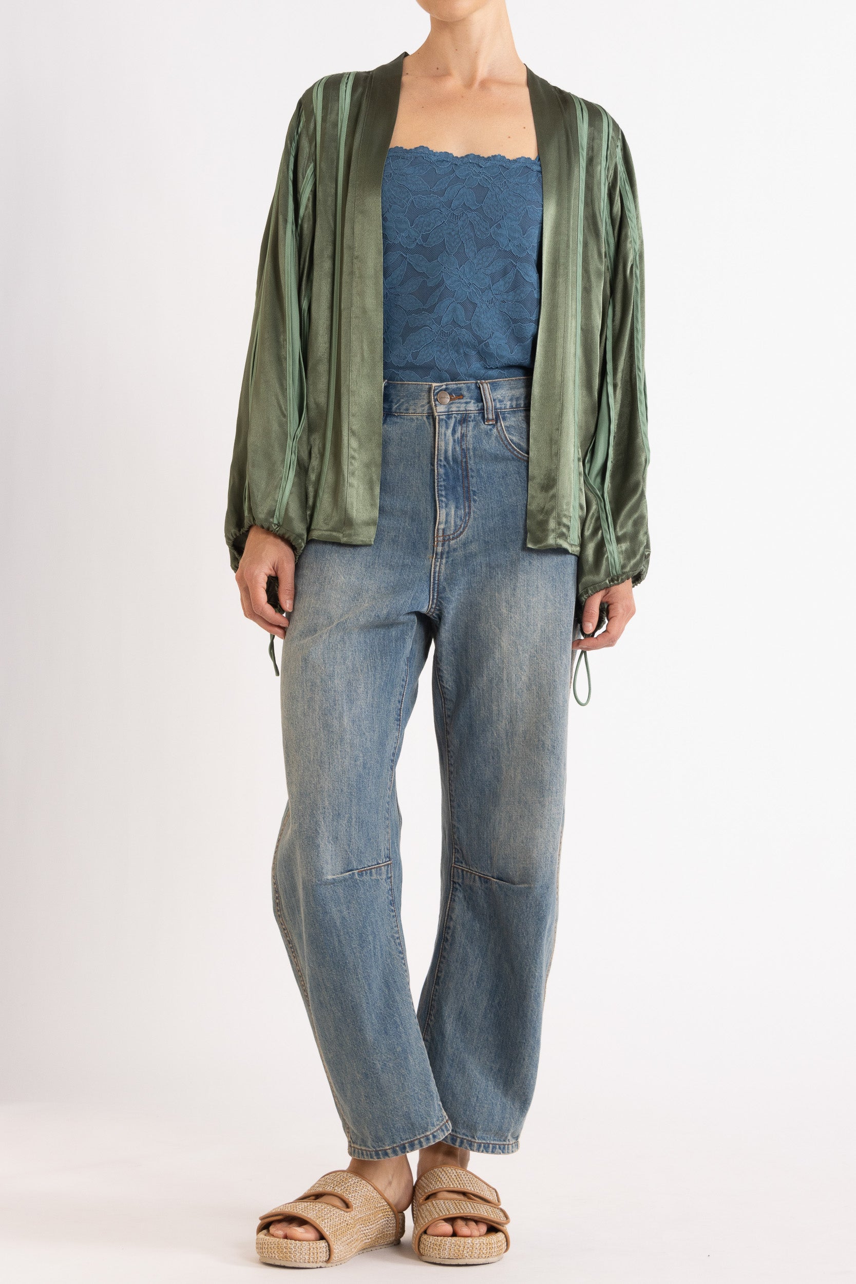 Model wearing green box pleat jacket, blue lace camisole & denim jean, front view