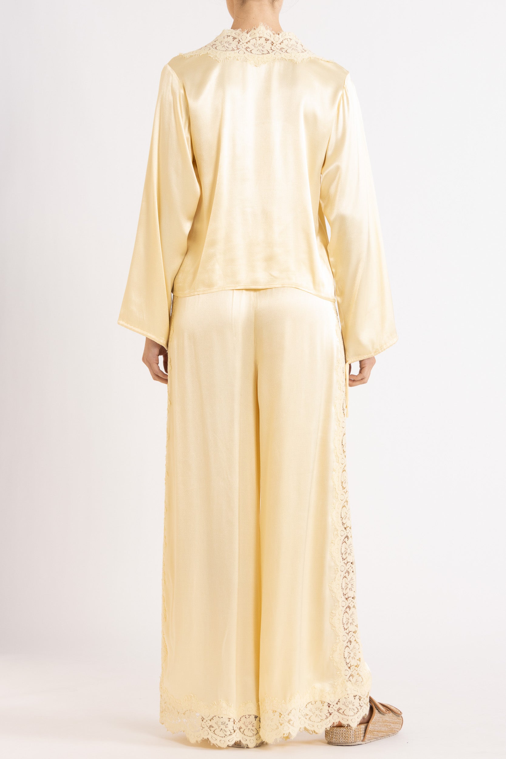 Woman wearing matching Vanilla lace-lined long sleeve top and pant on a white background