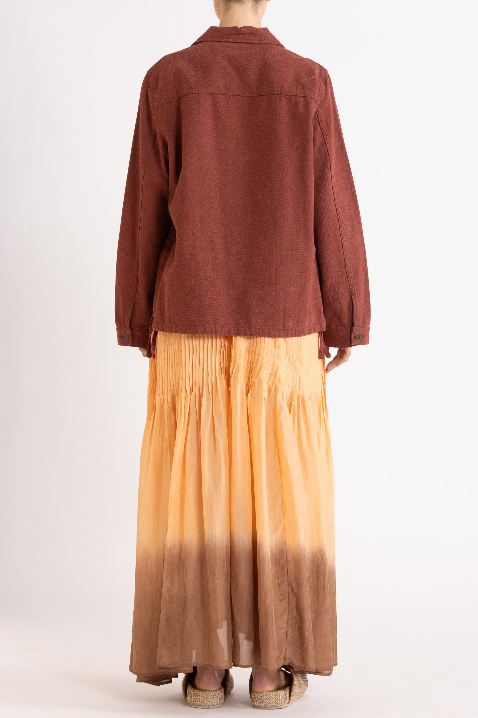 Model wearing burgundy cotton-twill utility jacket & peach dip-dye silk dress, back view