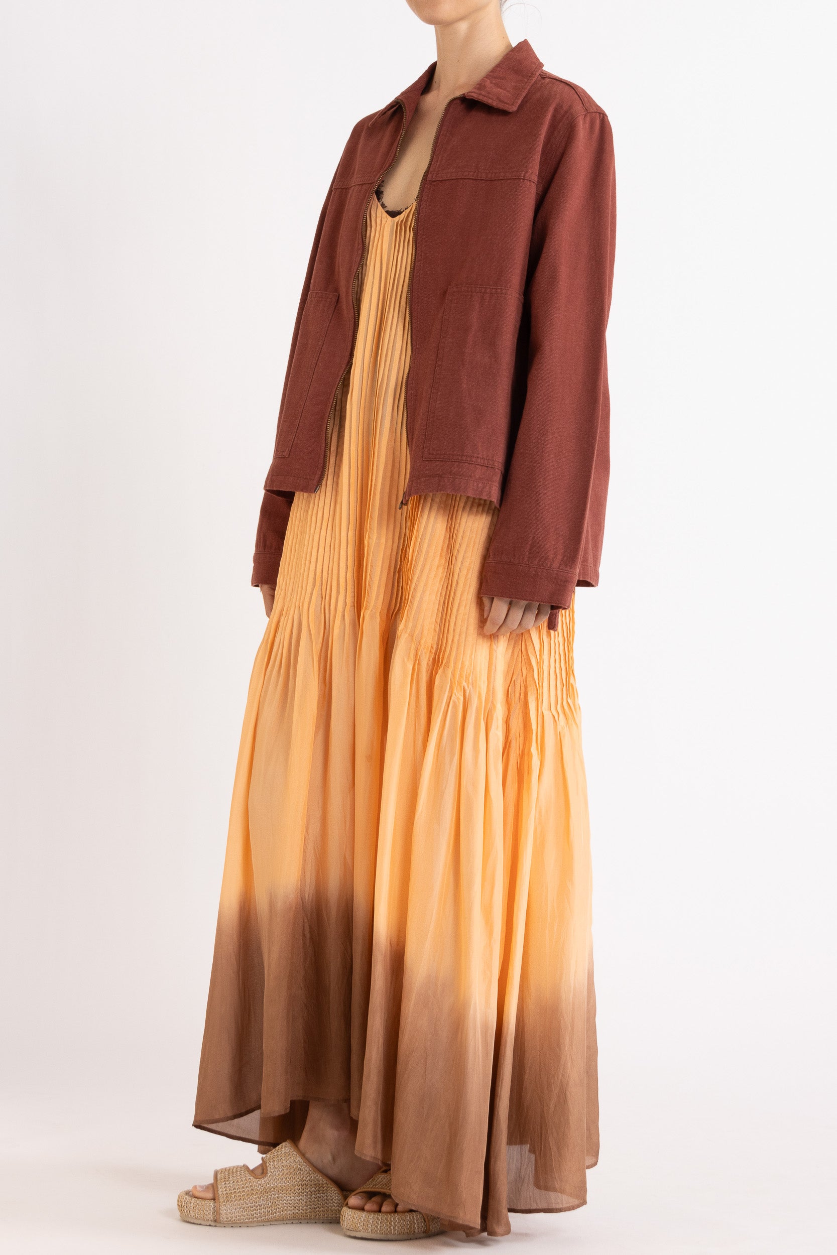 Model wearing burgundy cotton-twill utility jacket & peach dip-dye silk dress, front-side view