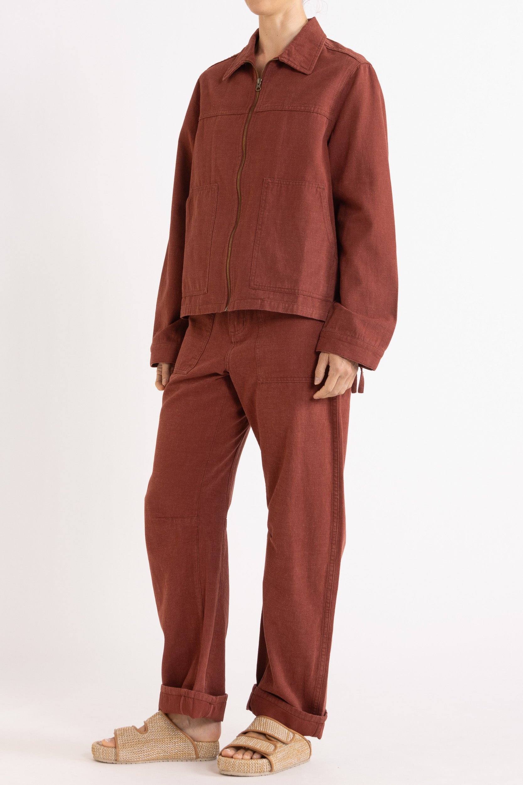 Model wearing burgundy cotton-twill utility jacket & pant, front-side view