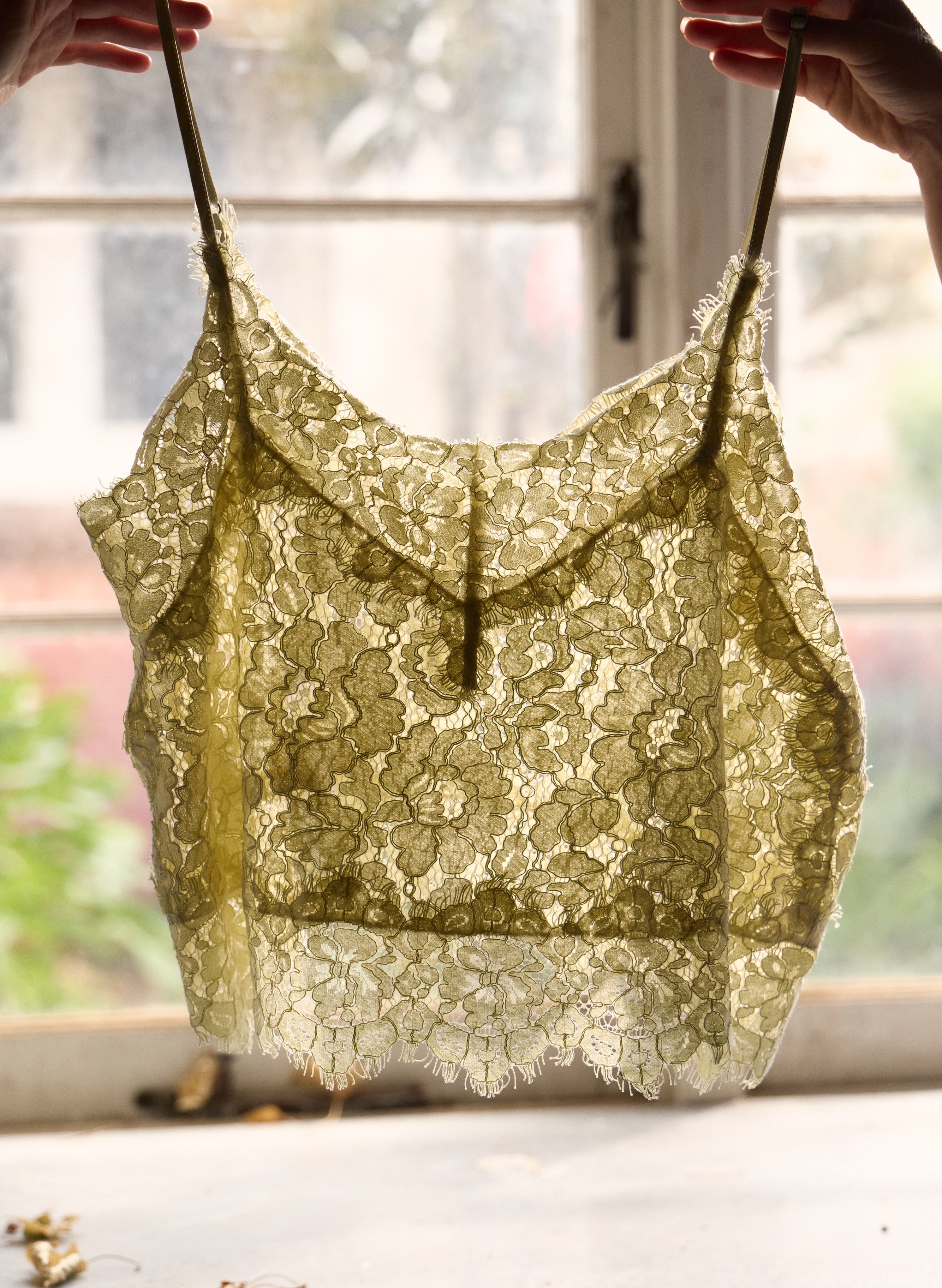 Lace top held up against a window with natural light