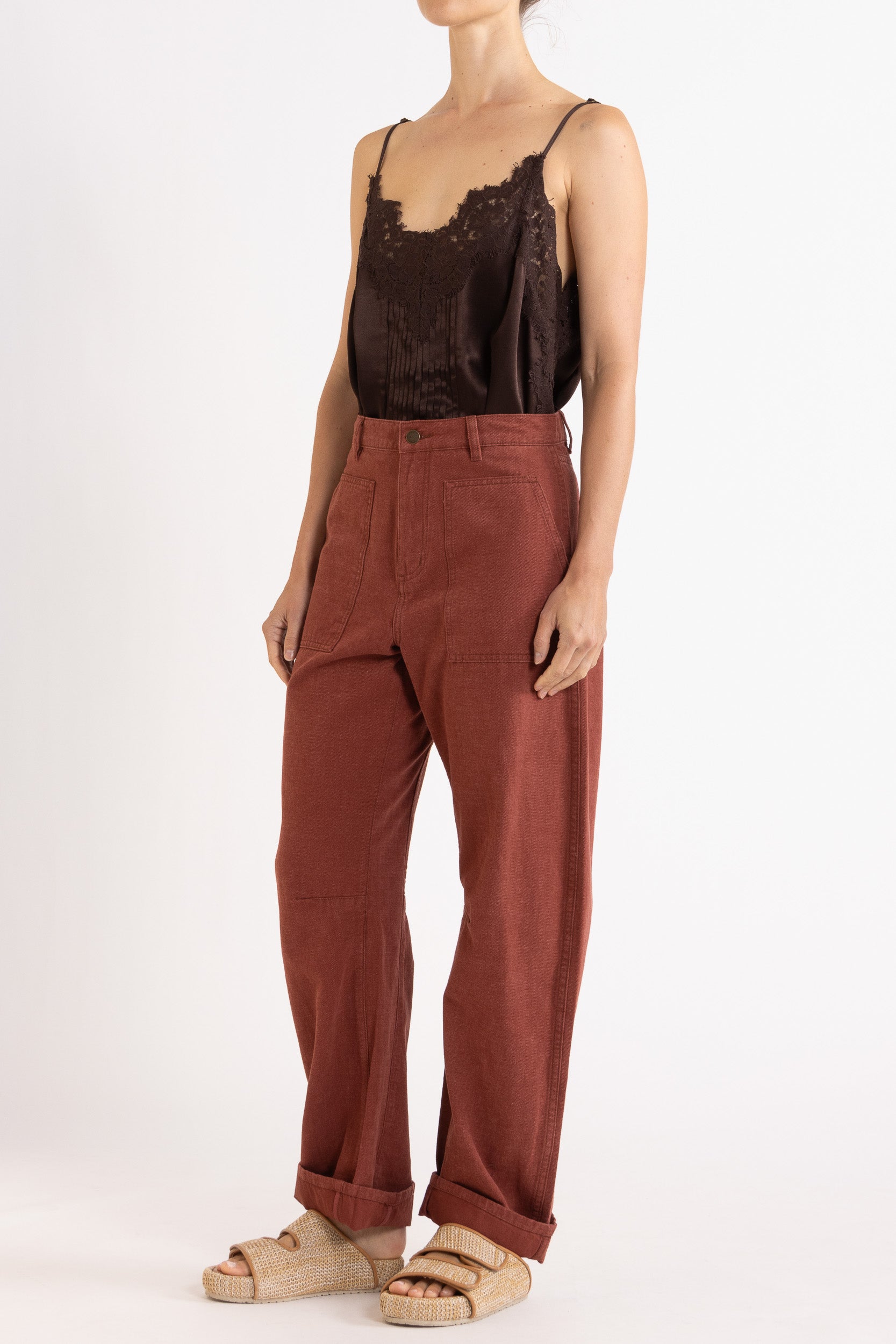 Model wearing chocolate satin cami with lace trims & burgundy cotton-twill pant, front-side view