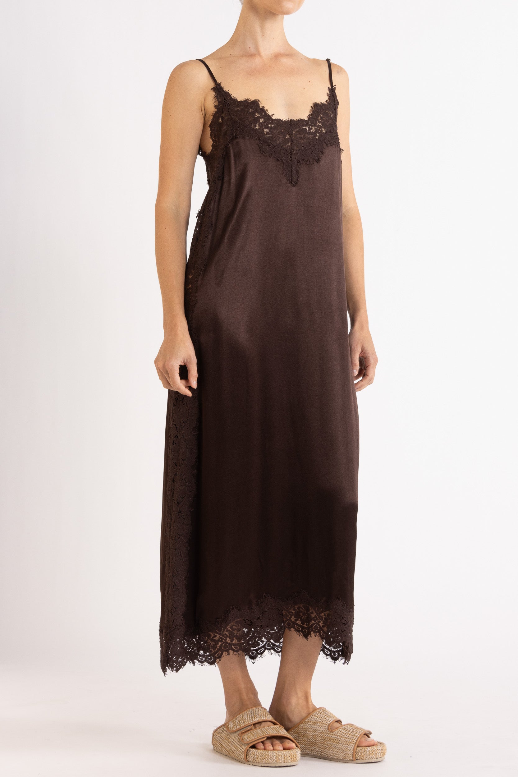 Woman wearing Chocolate  lace-trimmed camisole slip dress. 