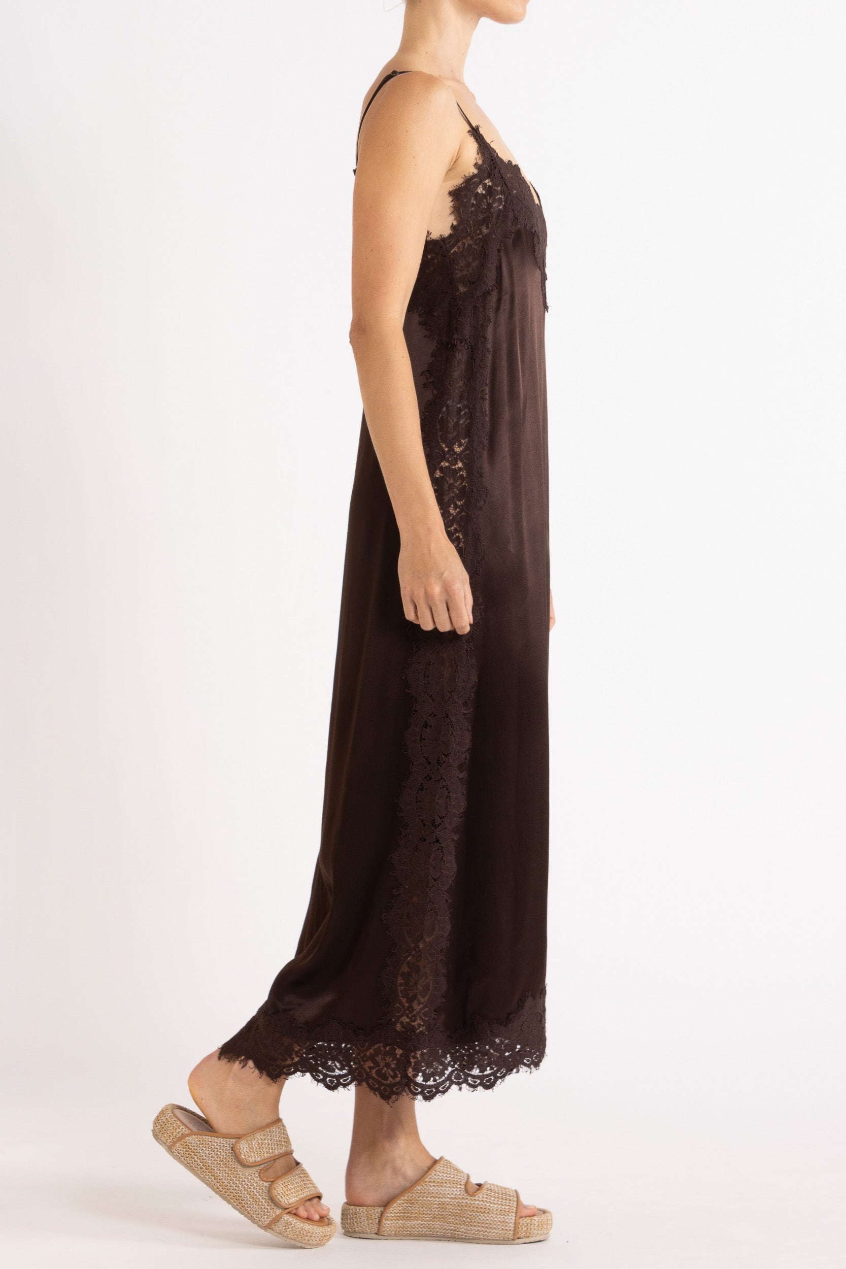 Woman wearing Chocolate  lace-trimmed camisole slip dress. 
