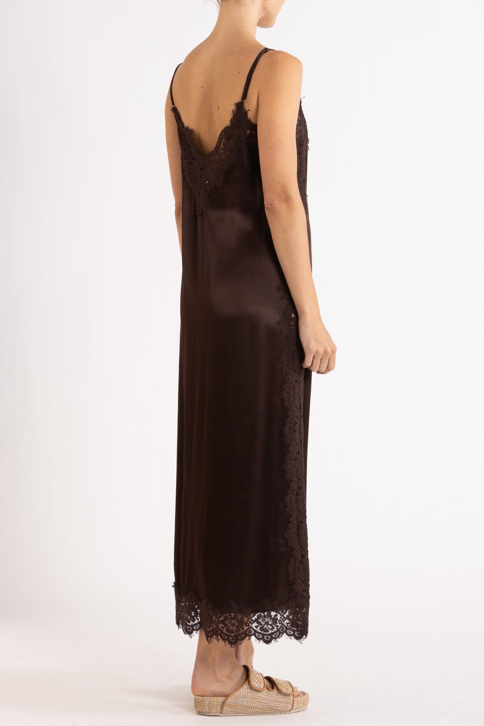 Woman wearing Chocolate  lace-trimmed camisole slip dress. 