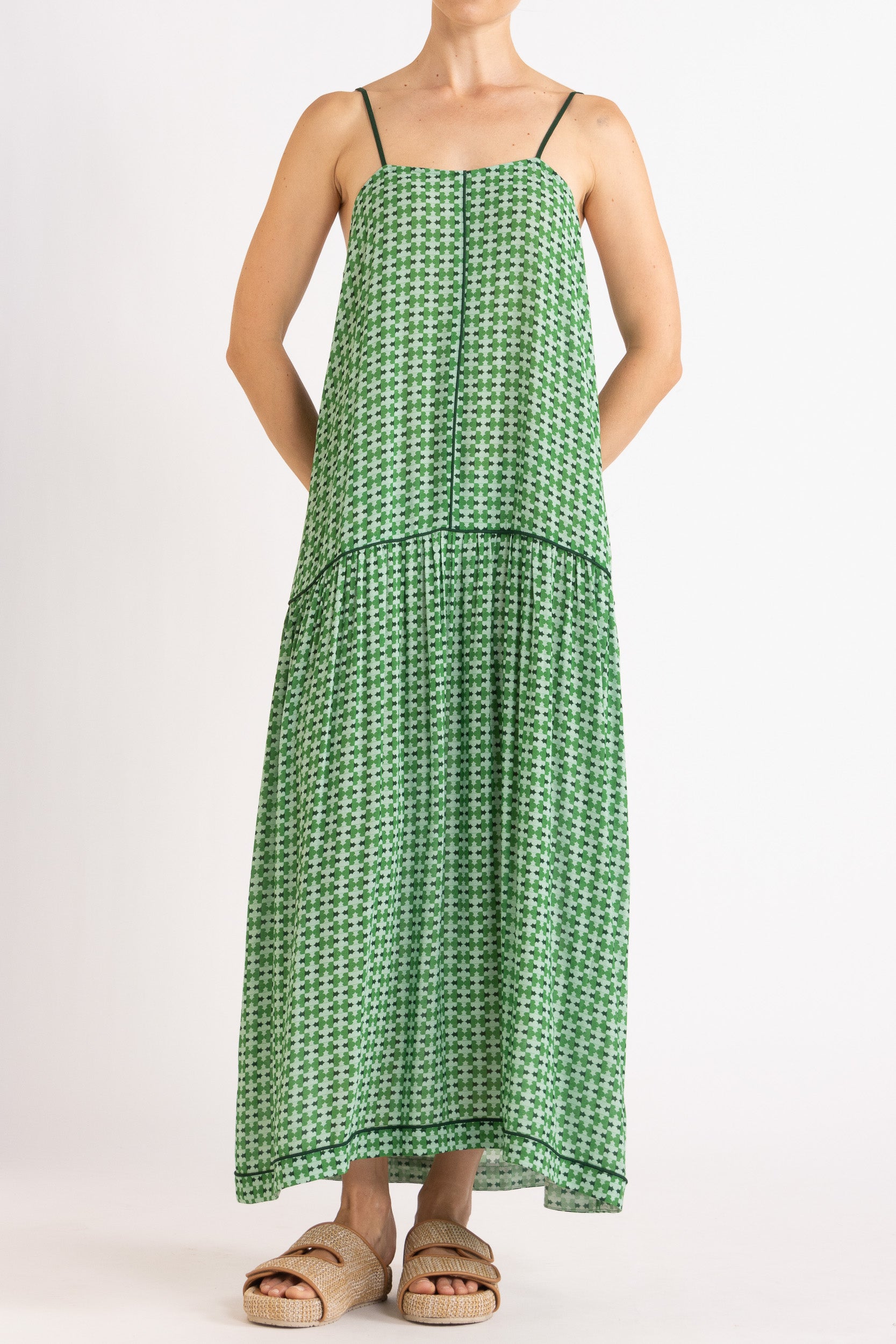 Model wearing green patterned dress, front view