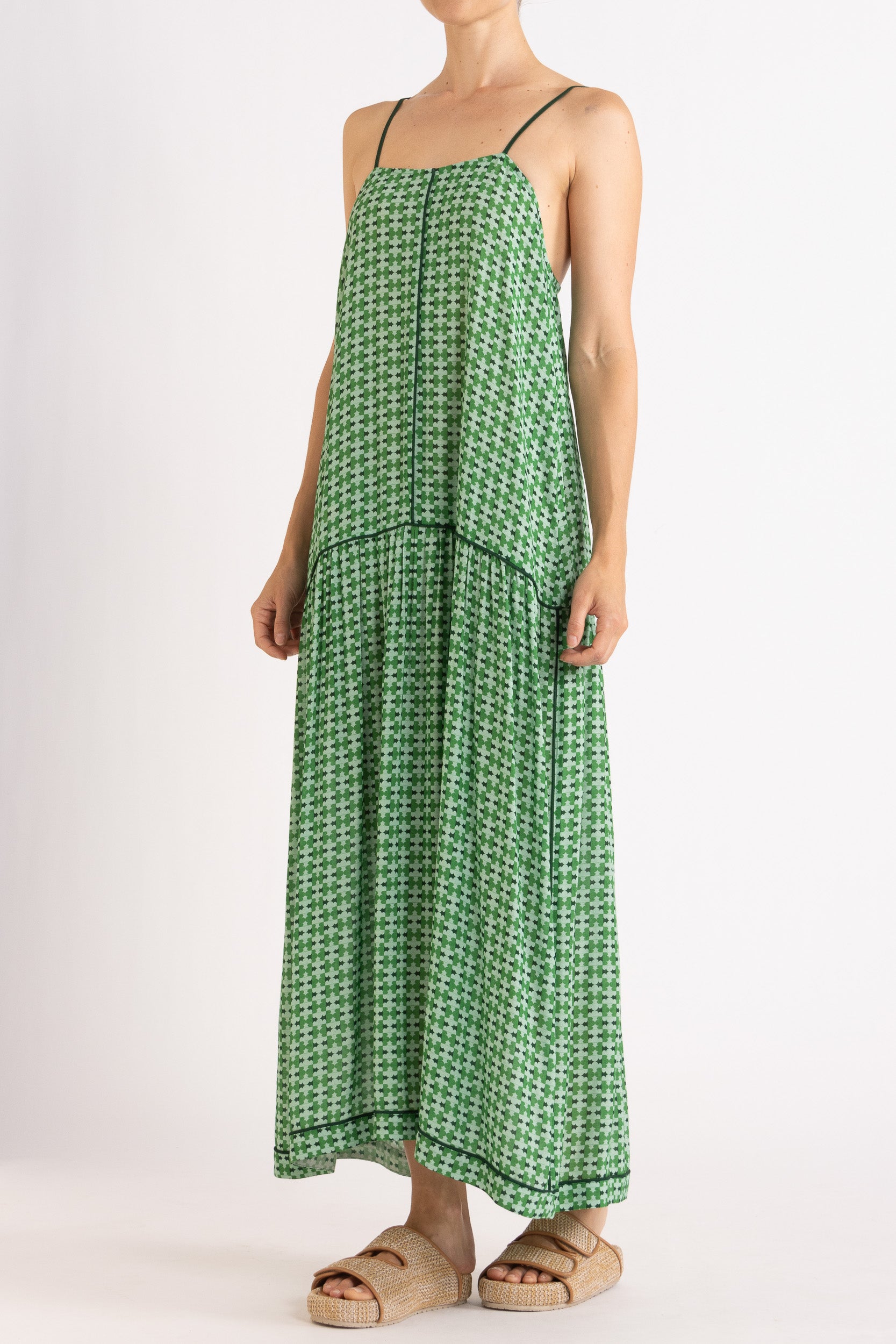 Model wearing green patterned dress, front-side view