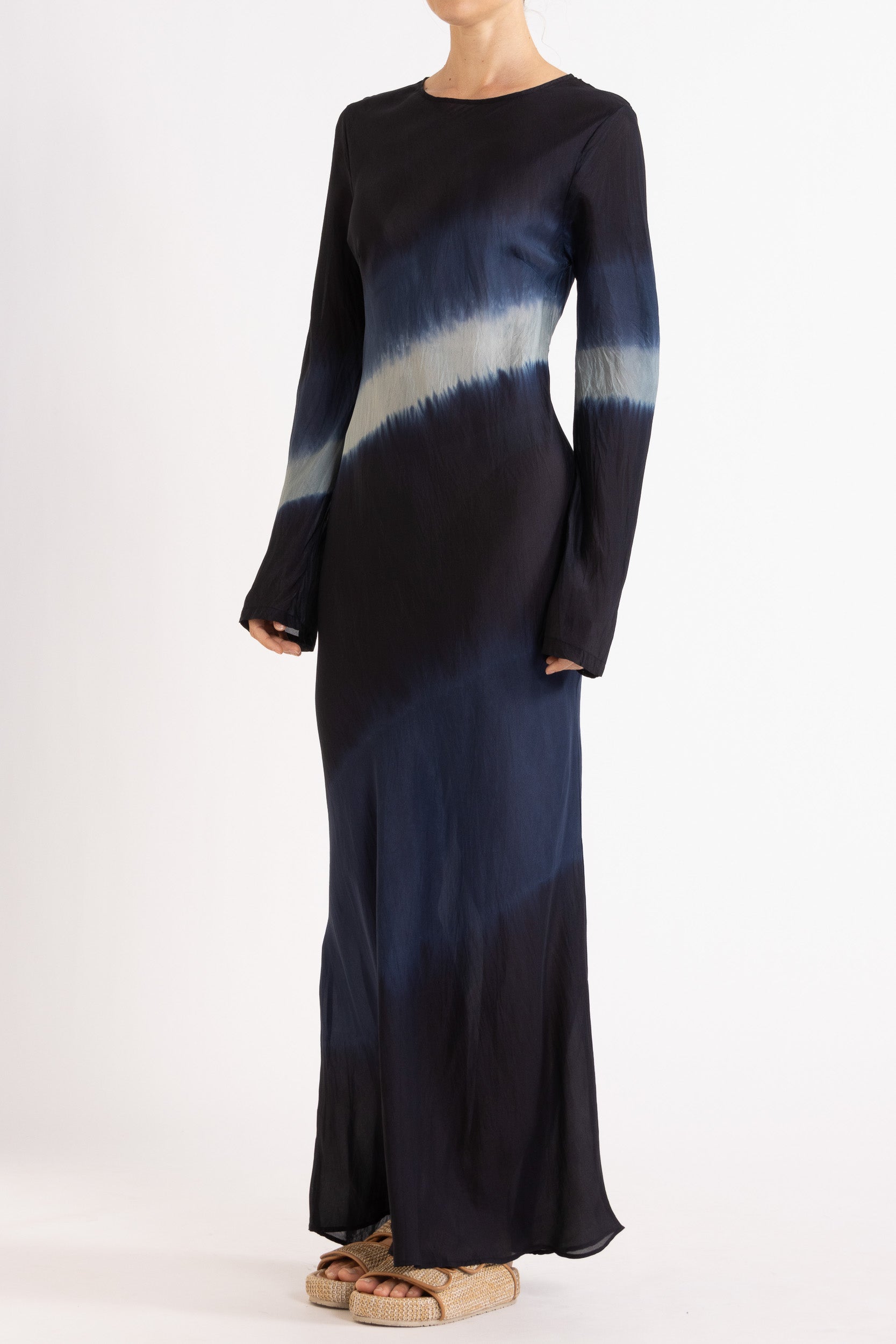Woman wearing a silk Habotai long Sleeve maxi dress hand tie dyed in ocean tones 