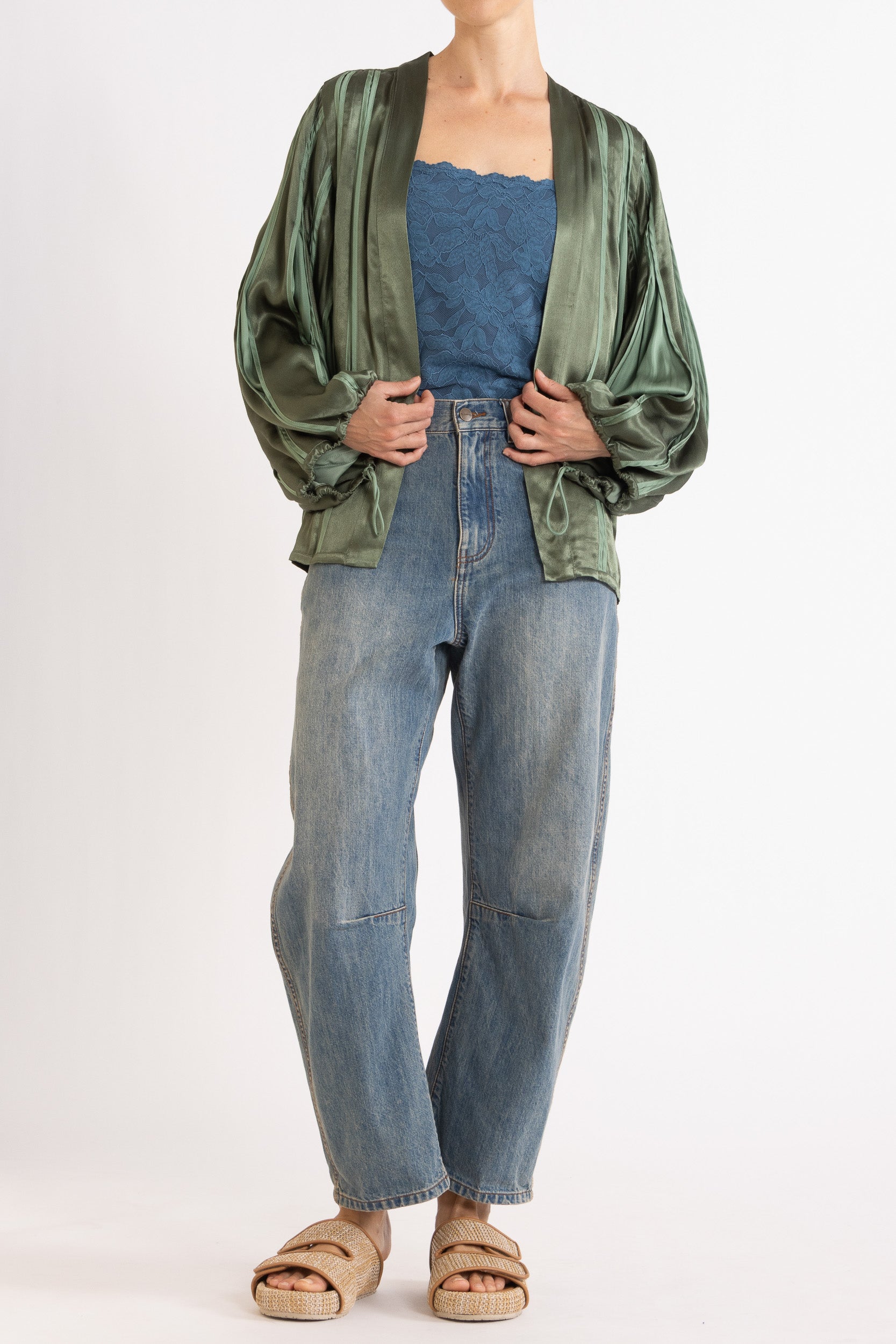 Model wearing green box pleat jacket, blue lace camisole & denim jean, front view