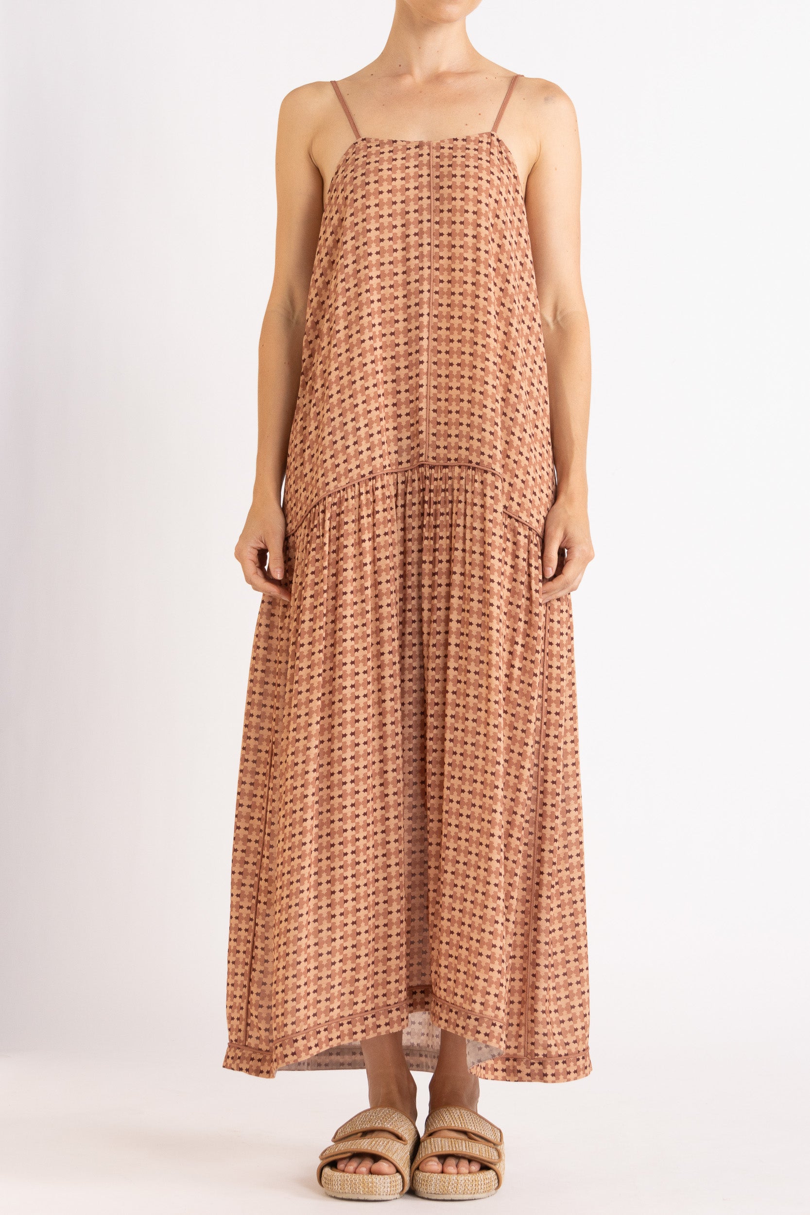 Model wearing peach patterned dress, front view