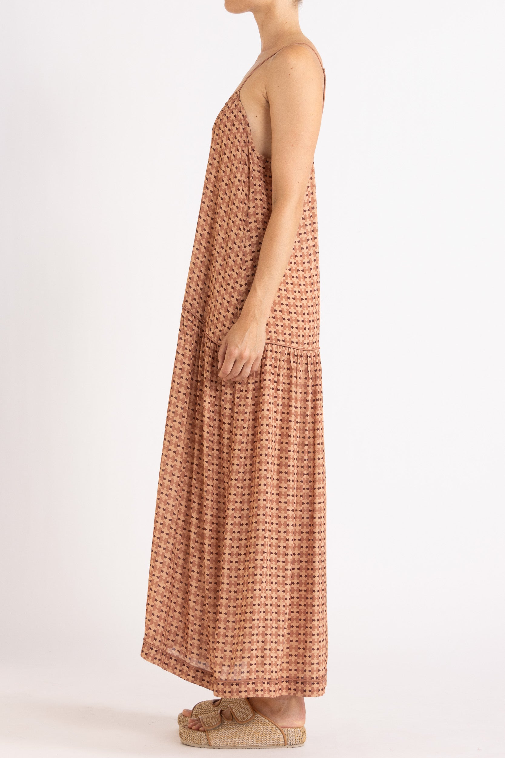 Model wearing peach patterned dress, side view