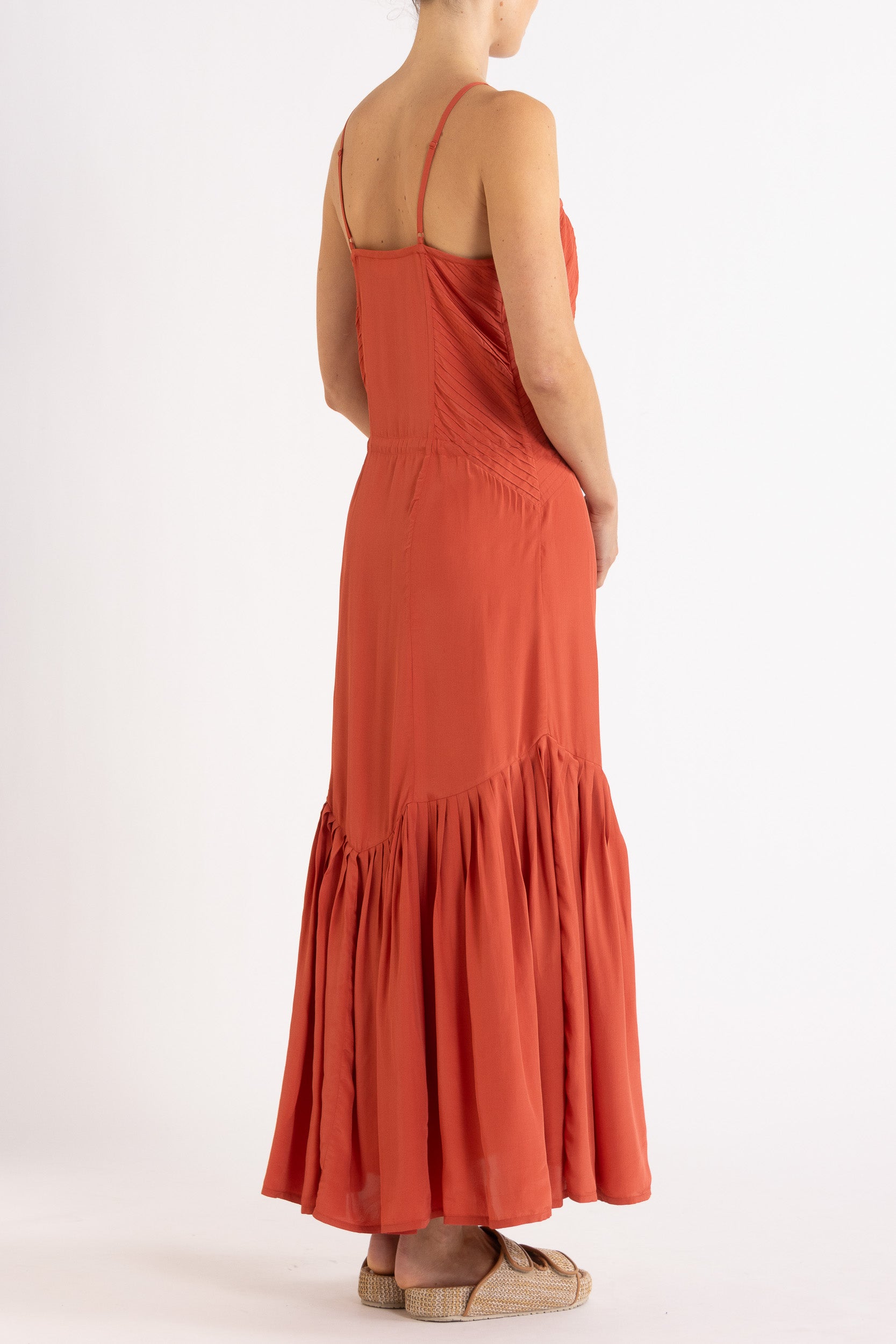 Woman wearing a red dress with floral embroidery on a white background