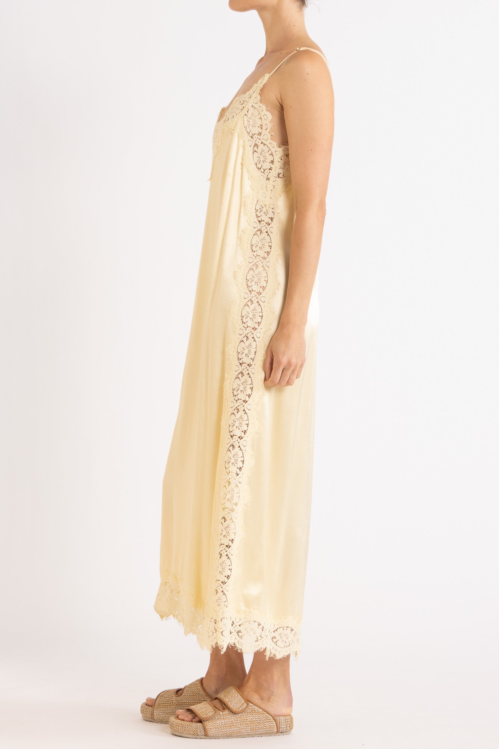 Woman wearing vanilla  lace-trimmed camisole slip dress