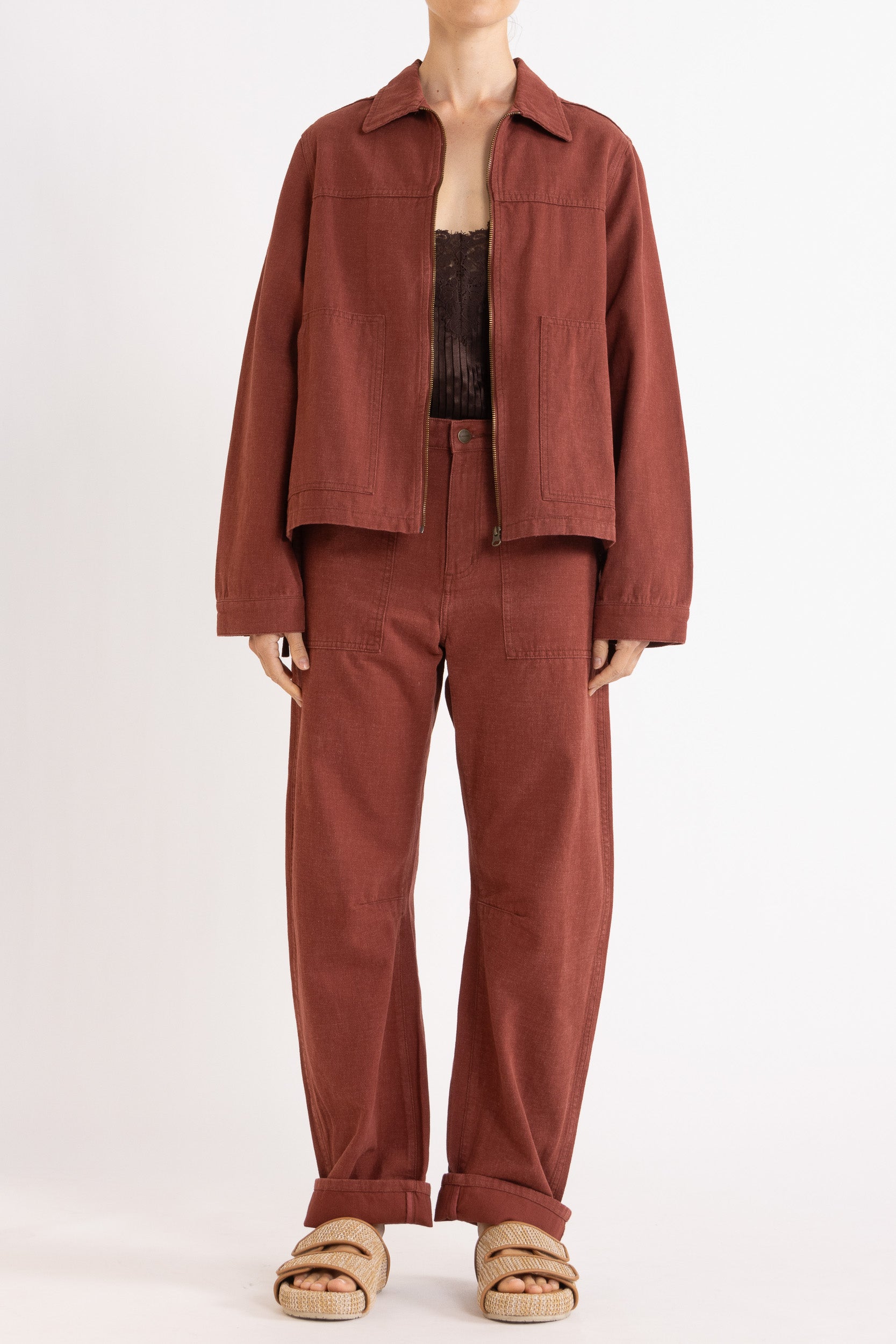 Model wearing burgundy cotton-twill utility jacket, chocolate satin cami with lace trims & burgundy cotton-twill pant, front view